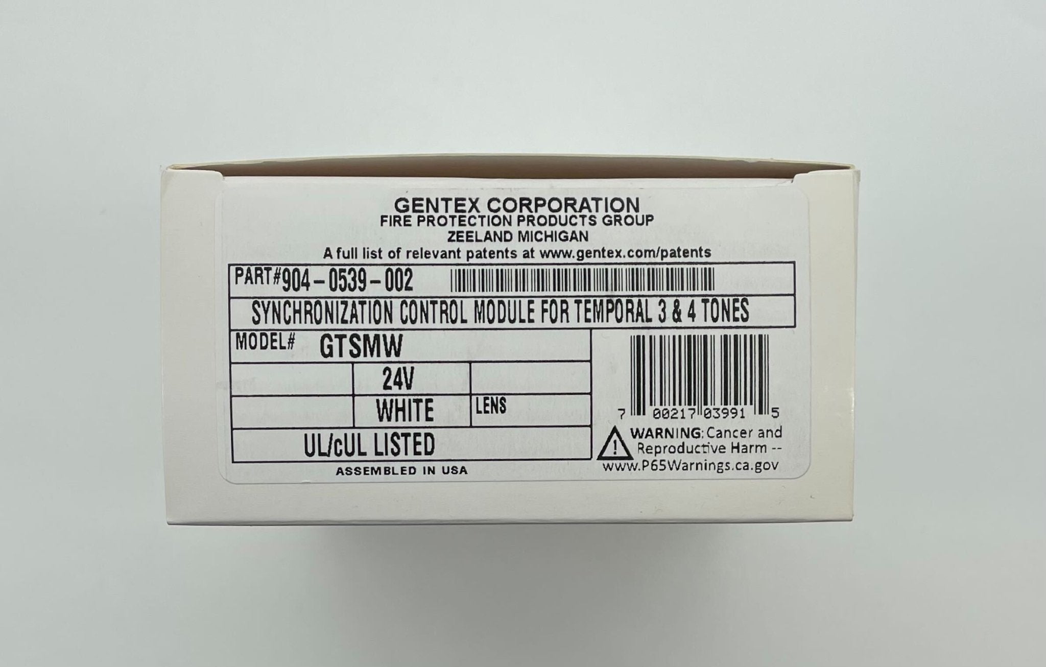 Gentex GTSM-W gangable synchronization module, a sleek black sync module with ports for building automation systems.