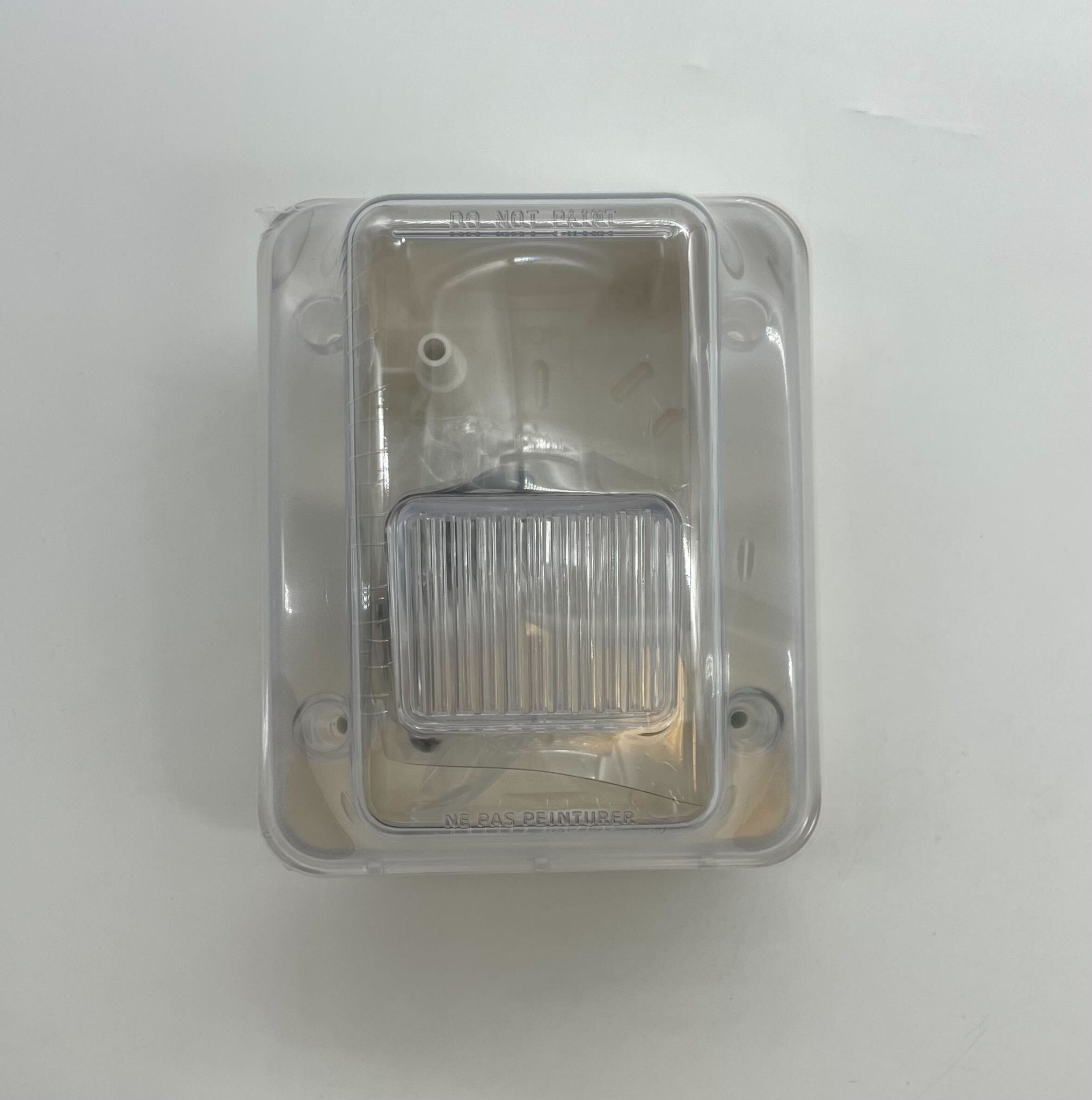 Gentex WGECB24-75PWW horn strobe alarm with white housing and clear lens, mounted on wall for fire safety alert.