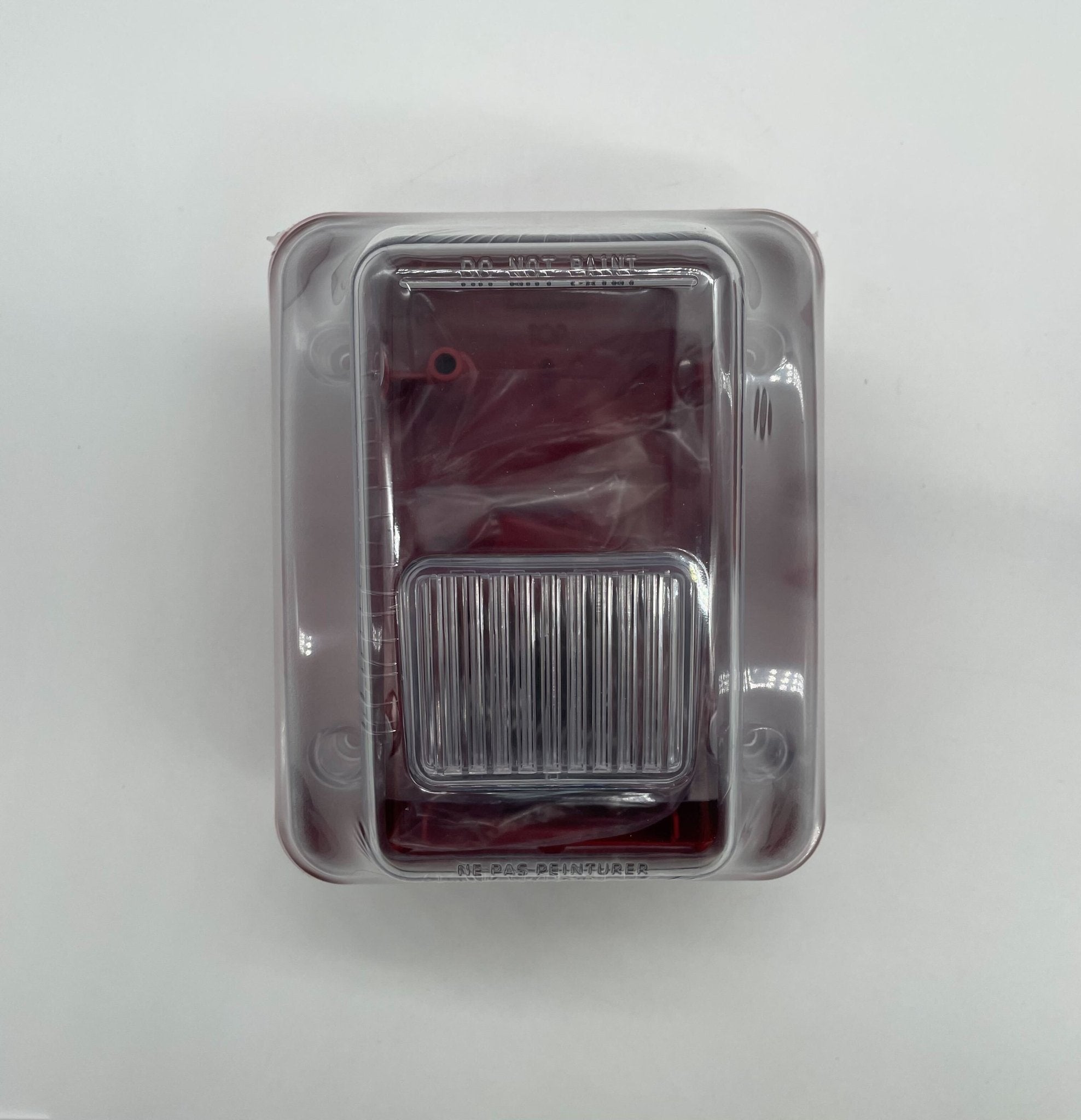 Gentex WGES24-75WR strobe light with red lens, mounted on a ceiling, used for emergency signaling and notification.