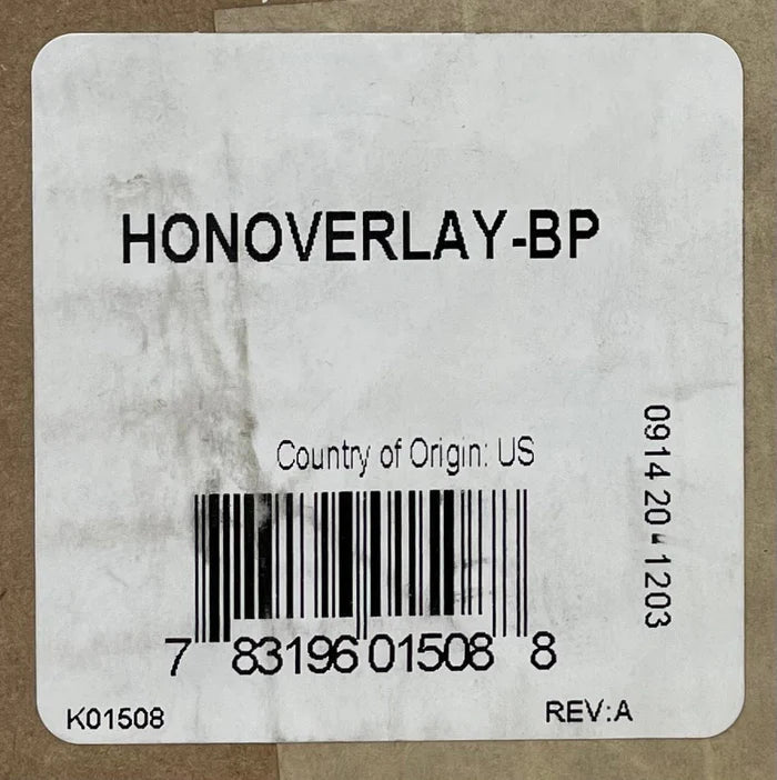 Honeywell HONOVERLAY-BP fire alarm control panel mounted on wall with display screen and control buttons.