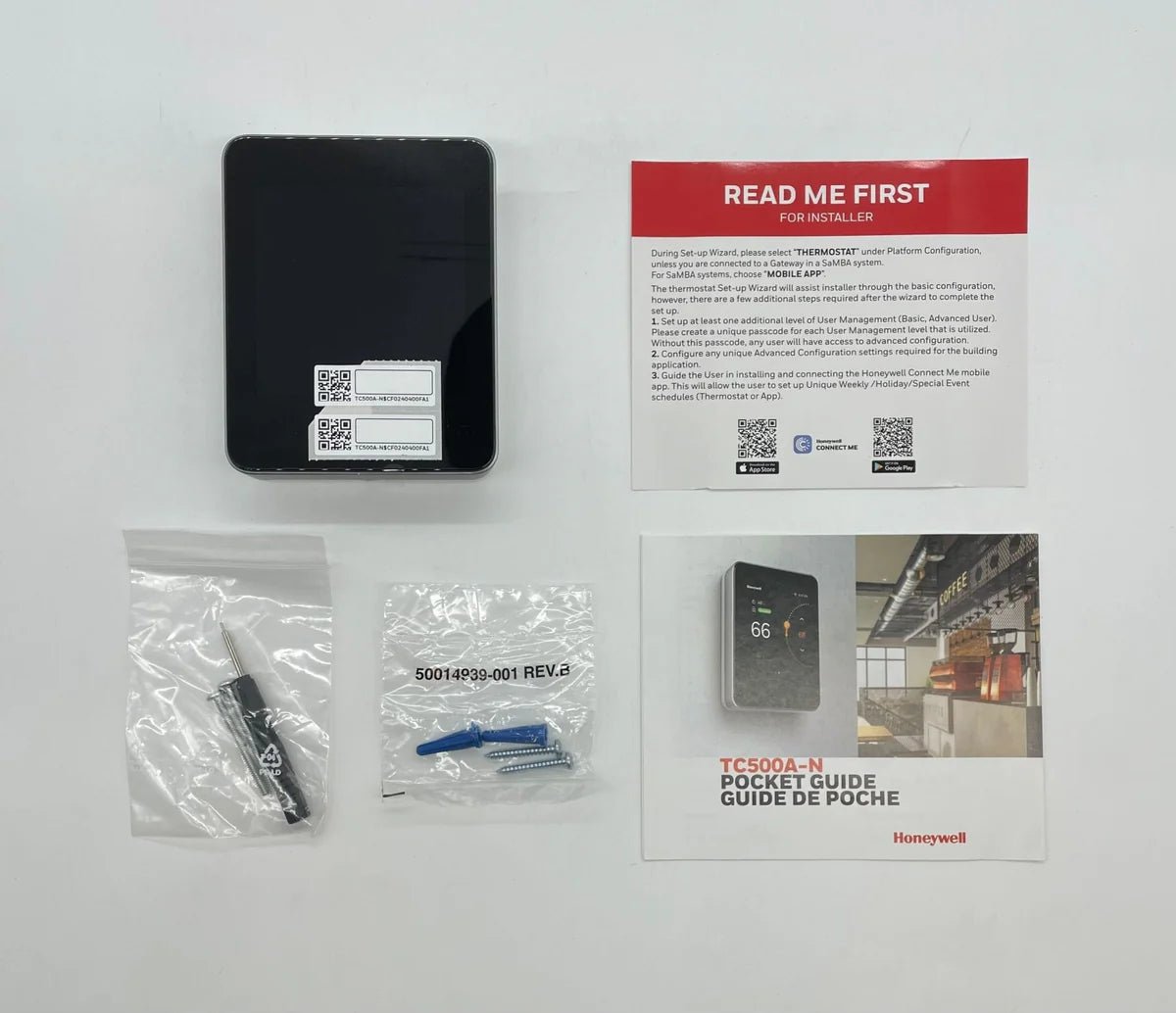 Honeywell TC500A-N digital thermostat mounted on wall with display and control buttons.
