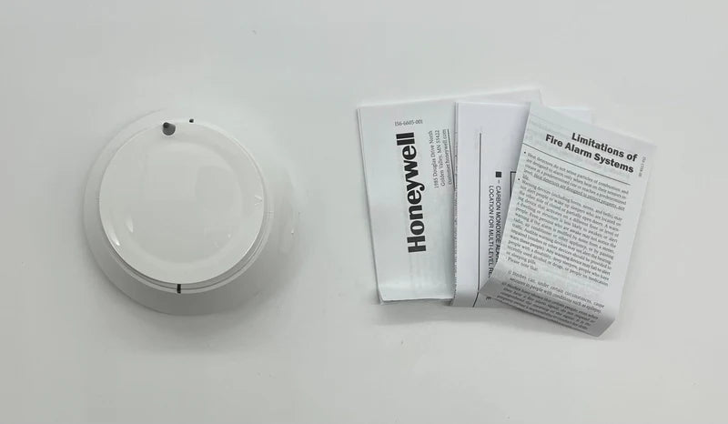 Honeywell TC840C3206 digital thermostat mounted on wall showing temperature display and control buttons