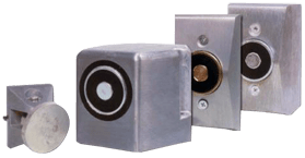 Edwards 1509-AQN5 door holder mounted on wall, silver metal finish, designed to keep doors open securely.