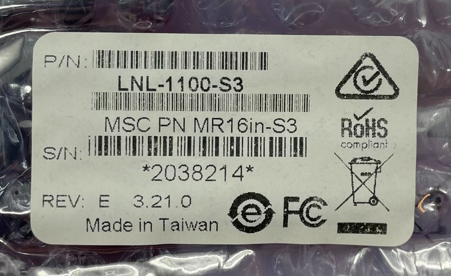 Lenel LNL-1100-S3 security module installed, showcasing its compact design and connection ports for access control systems.