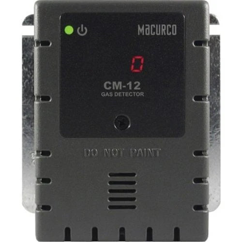 Macurco CM-12 carbon monoxide detector mounted on wall, black rectangular device with digital display and sensor.