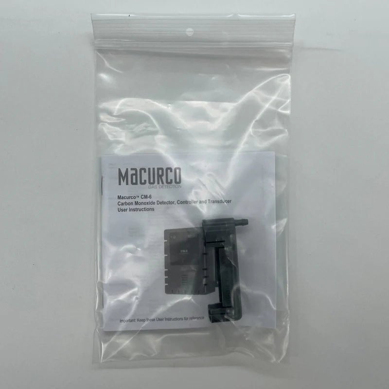Macurco CM-CH carbon monoxide detector mounted on a wall, with digital display and sensor indicator for safety monitoring.