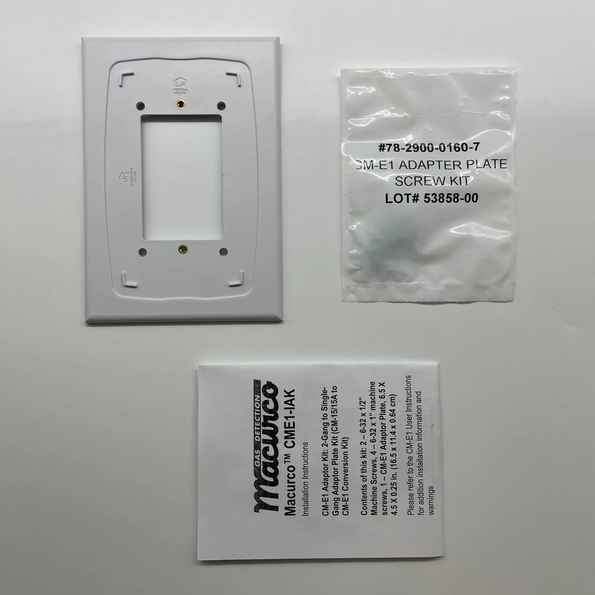 Macurco CM-E1-IAK carbon monoxide detector with digital display and mounting hardware, designed for residential safety.