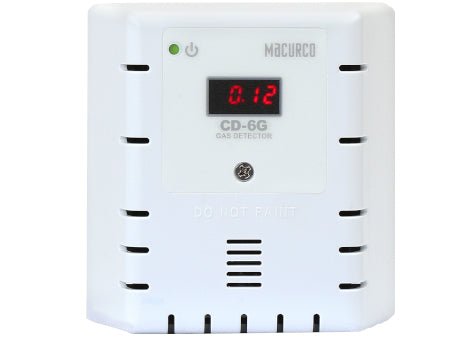 Macurco CD-6G gas detector sensor with digital display, mounted on wall for indoor air quality monitoring.