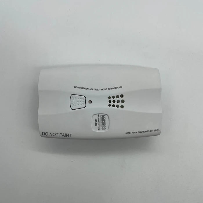 Macurco GD-2B gas detector with digital display and sensor for indoor air quality monitoring, shown in a professional setting.
