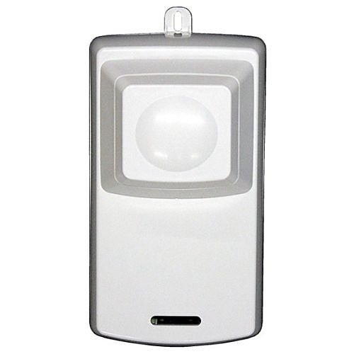 Napco PSIREN security alarm siren mounted on wall, black plastic housing with mounting bracket and warning labels.