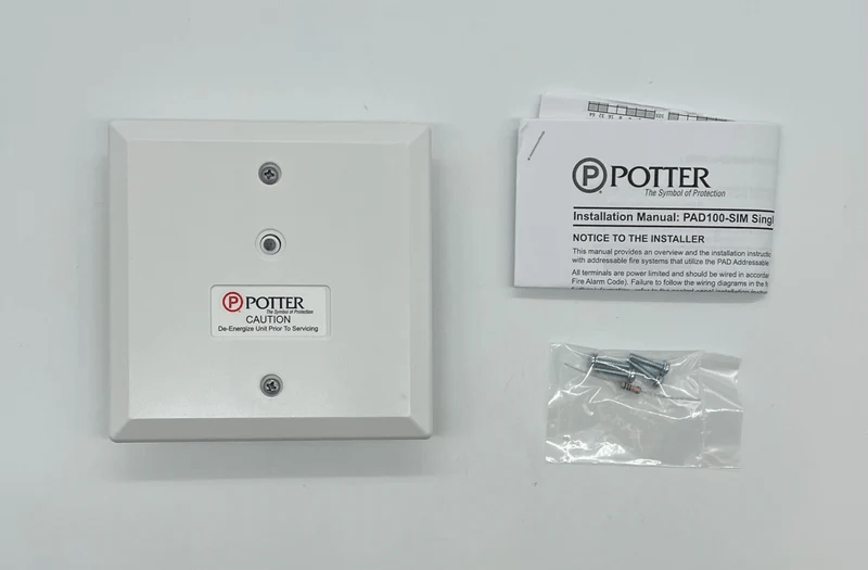 Potter PAD100-SIM safety relay device with green and red indicator lights, mounted on a panel for industrial automation.