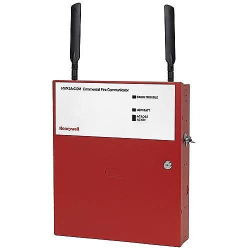 Fire-Lite HWF2A-COM fire alarm control module mounted on a panel with visible wiring and connection ports.