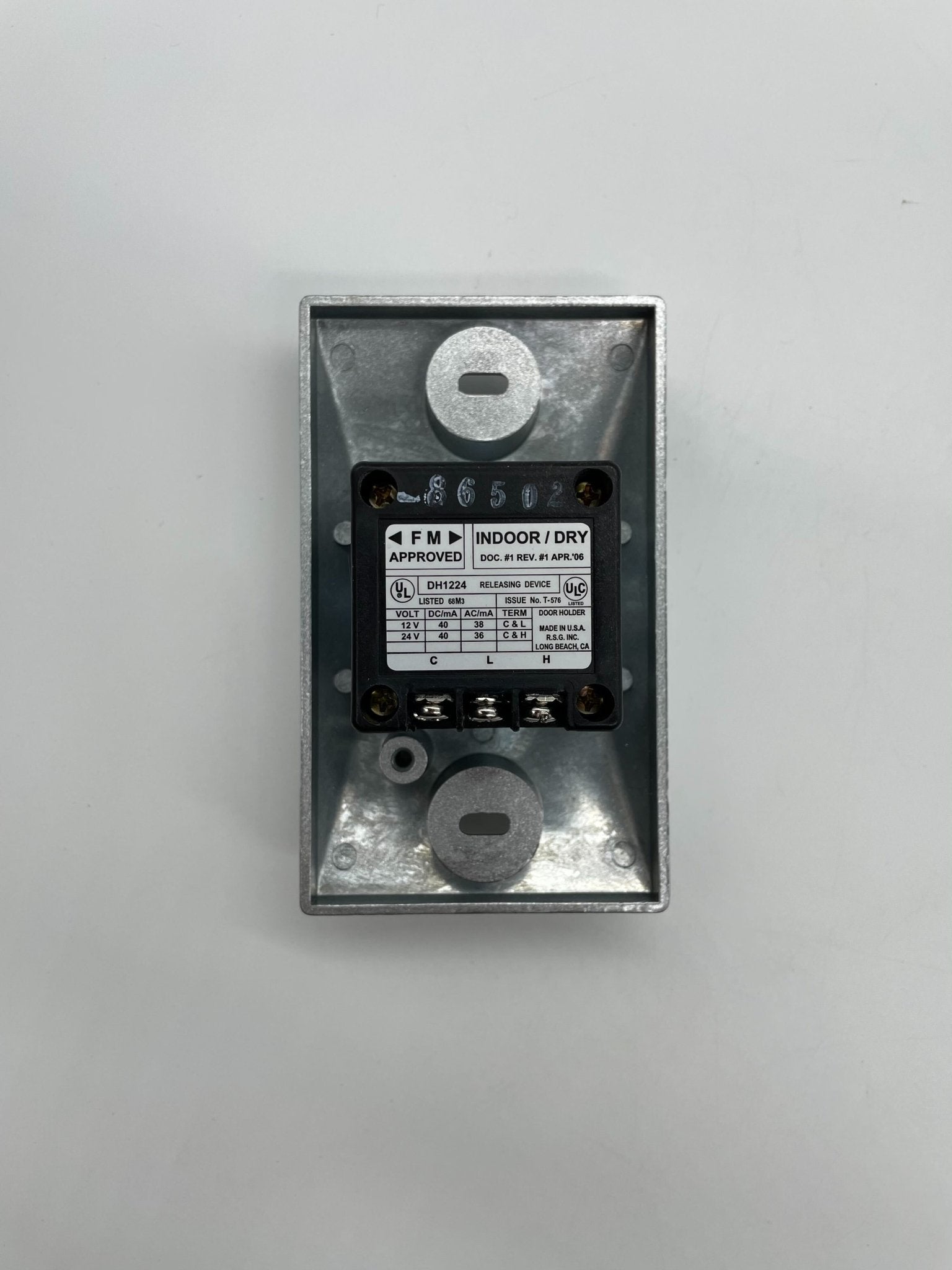 RSG DH1224SPC door holder mounted on a door, showcasing durable metal design for secure door positioning.