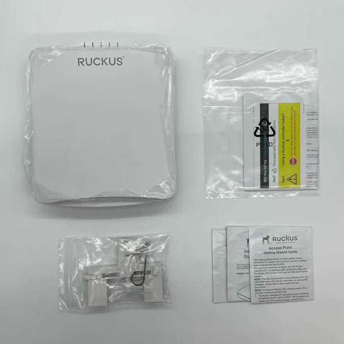 Ruckus R650 Wi-Fi 6 access point mounted on a ceiling with visible antennas and network cables.