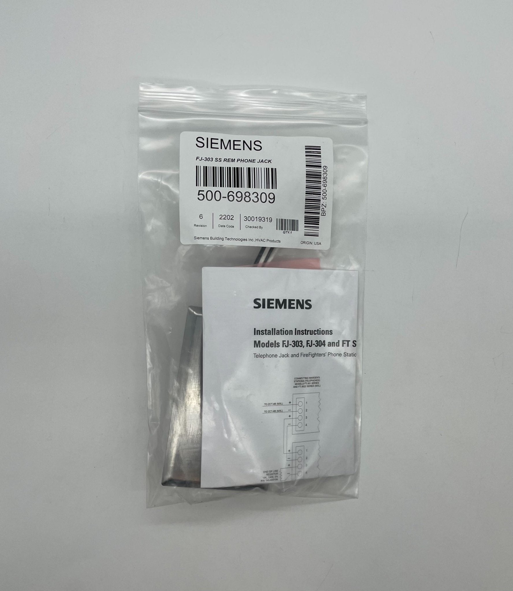 Siemens FJ-303SS fire alarm with stainless steel finish, mounted on wall, designed for residential or commercial safety use.