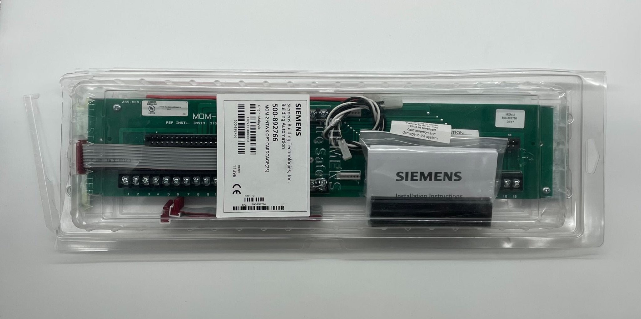 Siemens MOM-2 fire alarm device by JEM Systems Canada, showing the alarm unit with sensor and warning indicator.