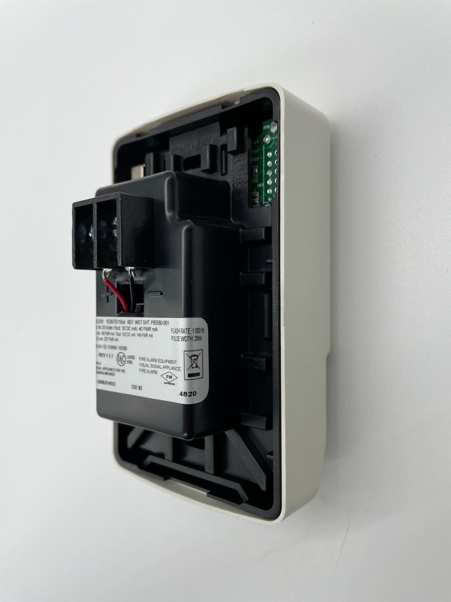 Siemens SLSWW-F fire alarm device with a sleek white design, mounted on a wall for safety and fire detection.