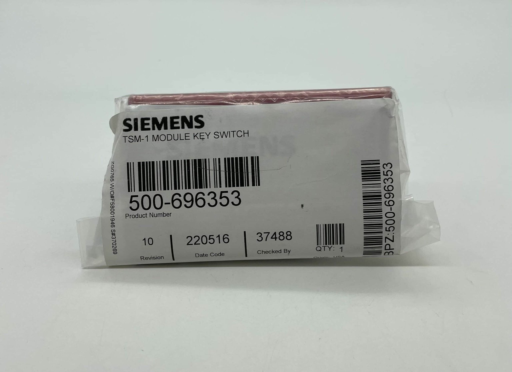 Siemens TSM-1 fire alarm device with red indicator light and mounting bracket, designed for fire safety systems.