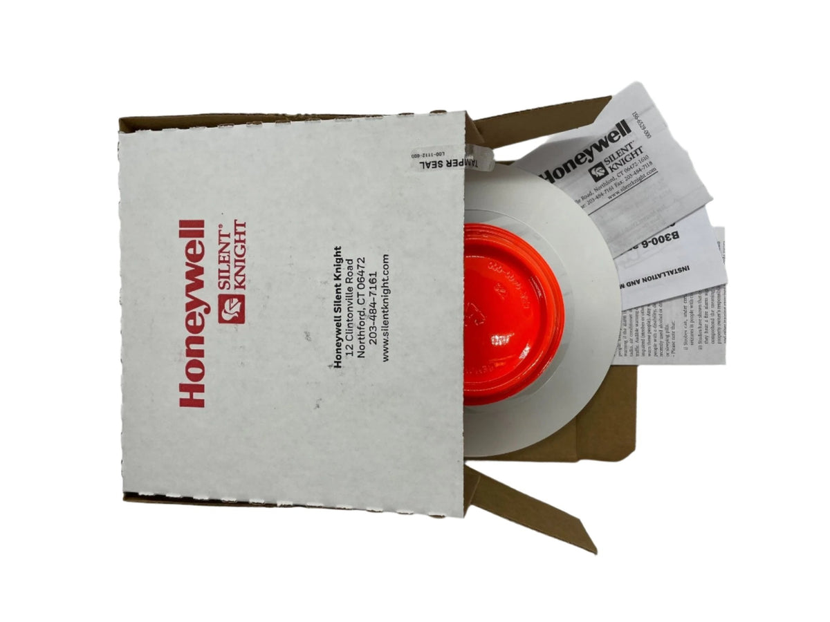 Silent Knight SK-HEAT-W addressable 2-wire heat detector, visible with its mounting base and sensor components.