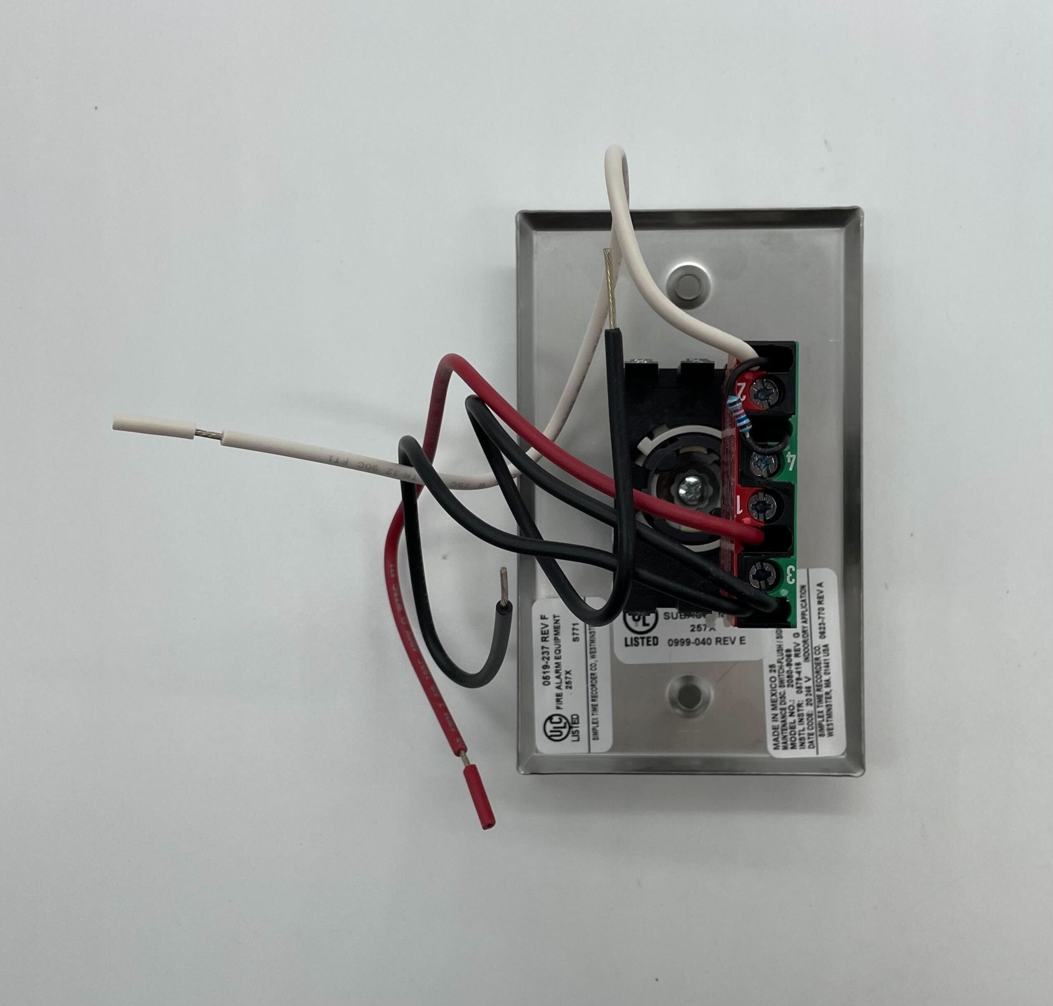 Simplex 2080-9069 fire alarm device by Simplex, showing a white alarm unit with indicator lights and mounting features.