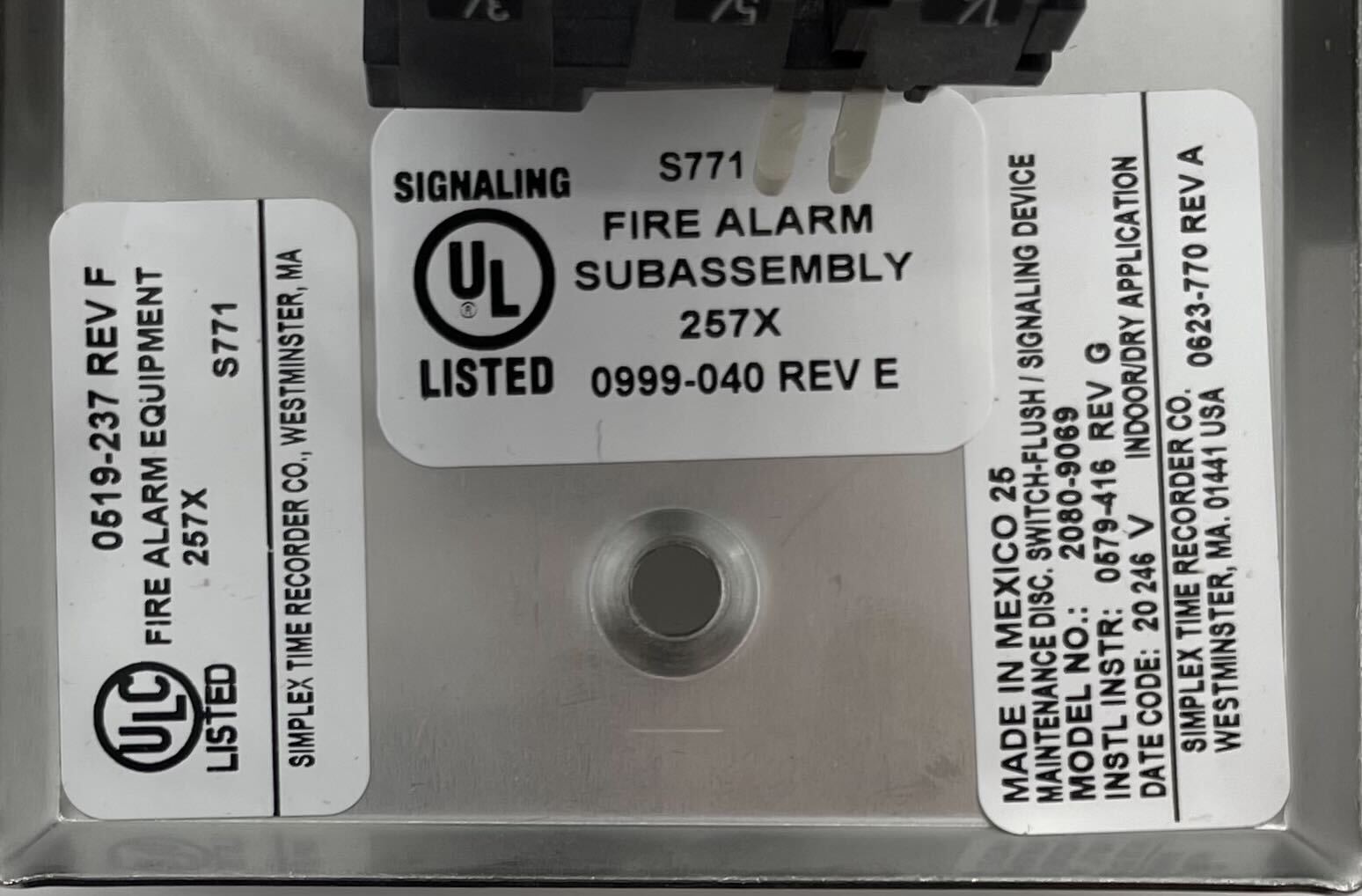 Simplex 2080-9069 fire alarm with digital display and alarm indicators, mounted on wall for fire safety detection.