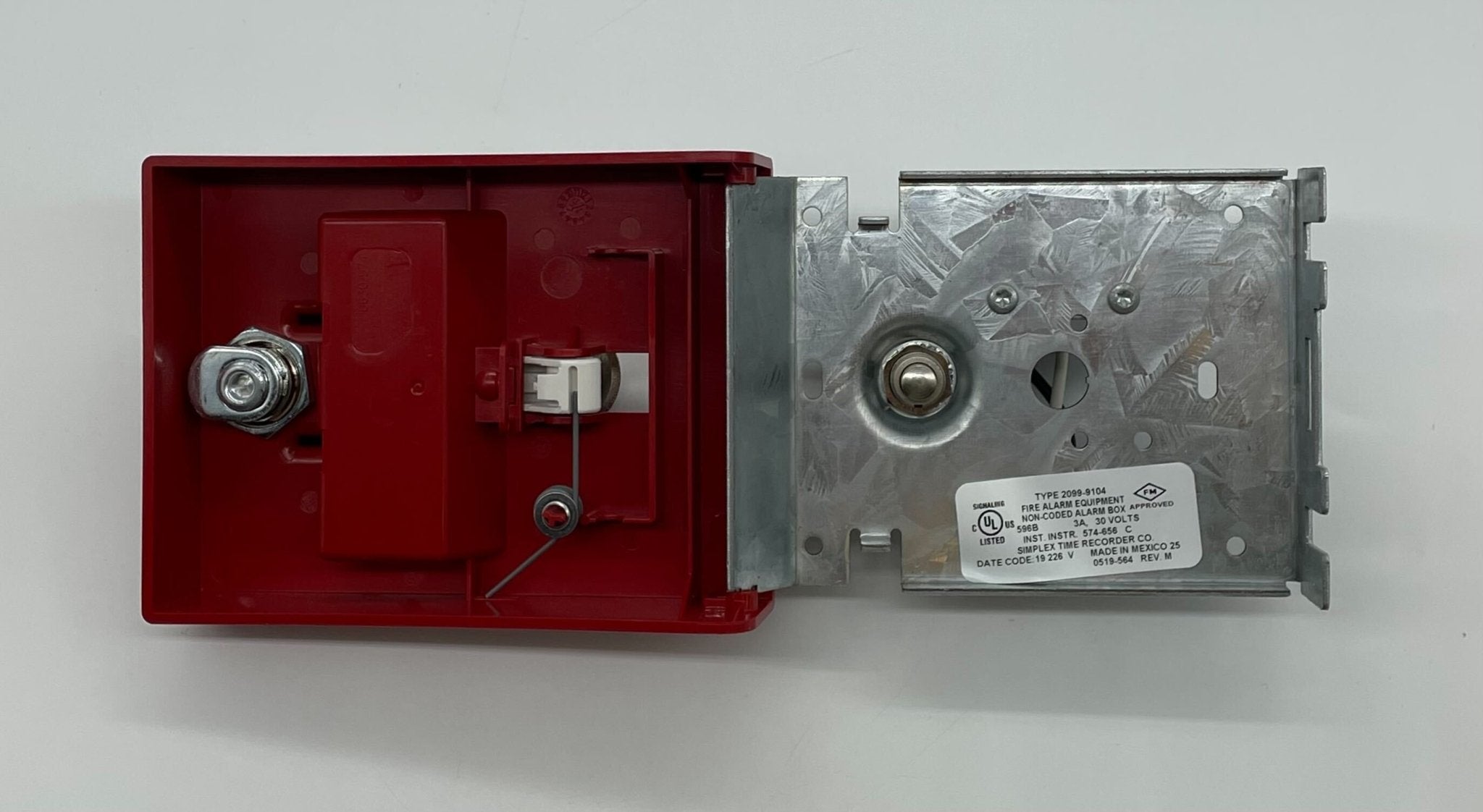 Simplex 2099-9104 pull station fire alarm device mounted on wall, black plastic housing with safety label, for emergency alerts