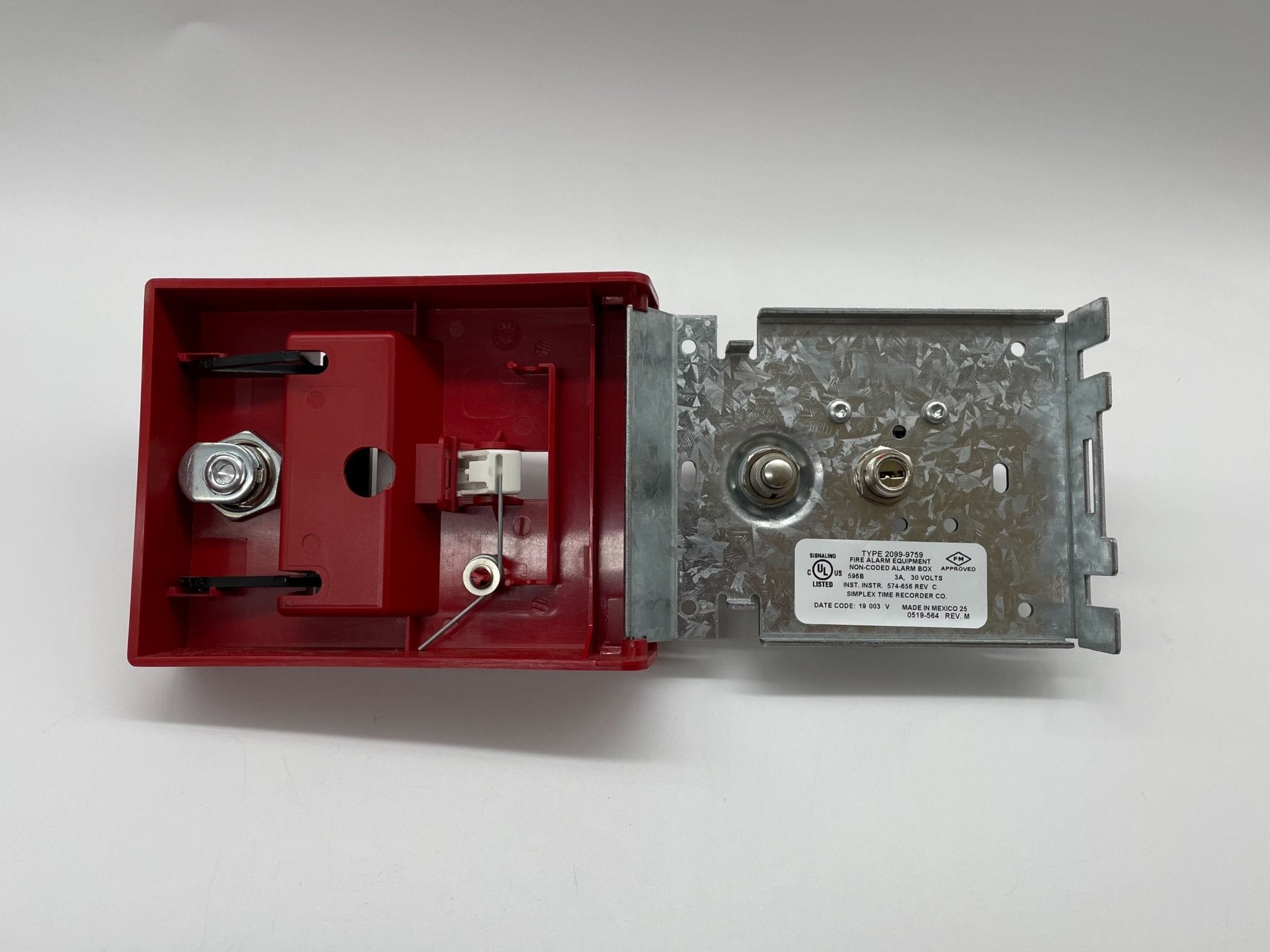 Simplex 2099-9759 pull station fire alarm switch, mounted on wall, with visible branding and emergency indicator.