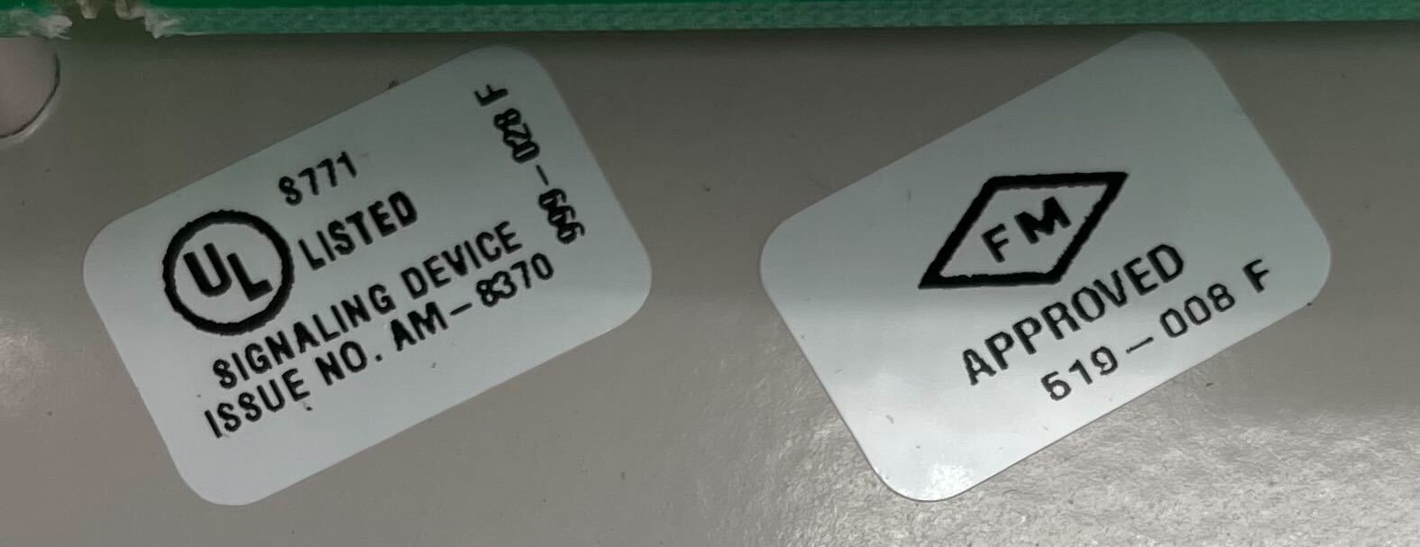 Simplex 2190-9169 fire alarm with white casing and mounting bracket, designed for building safety and fire detection.