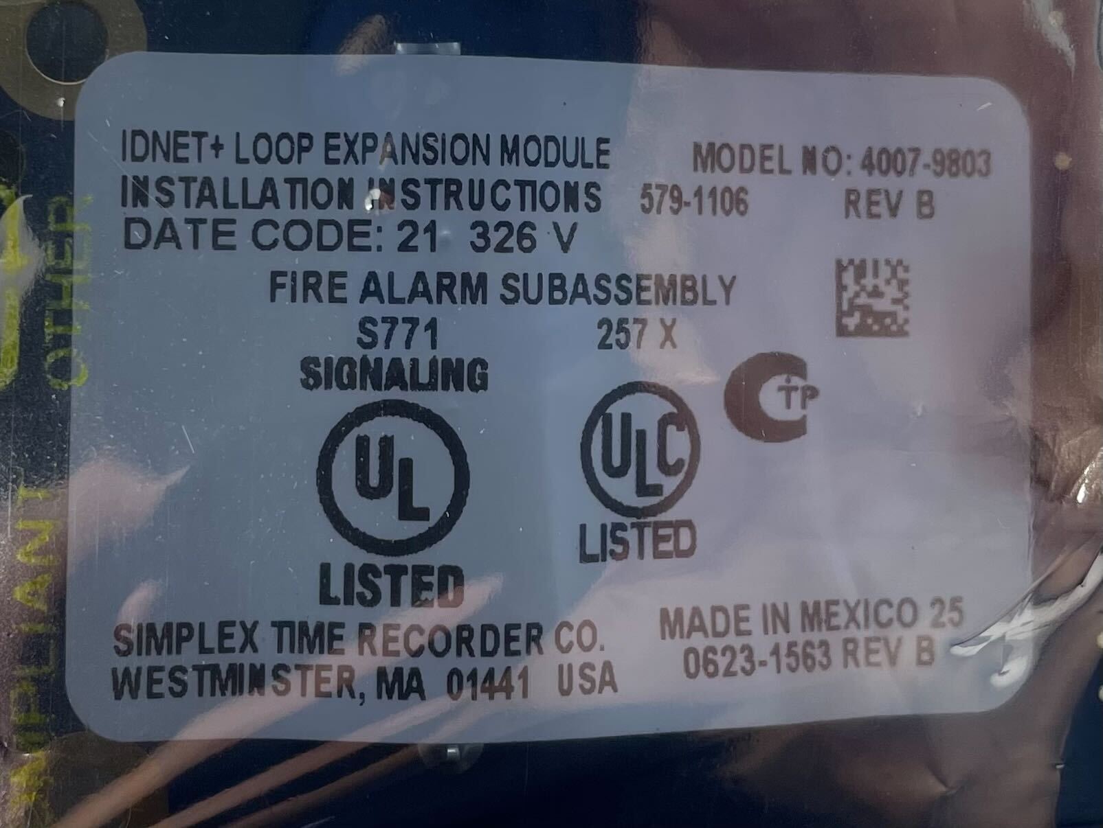 Simplex 4007-9803 fire alarm unit installed on ceiling, part of Simplex fire alarm system for building safety.