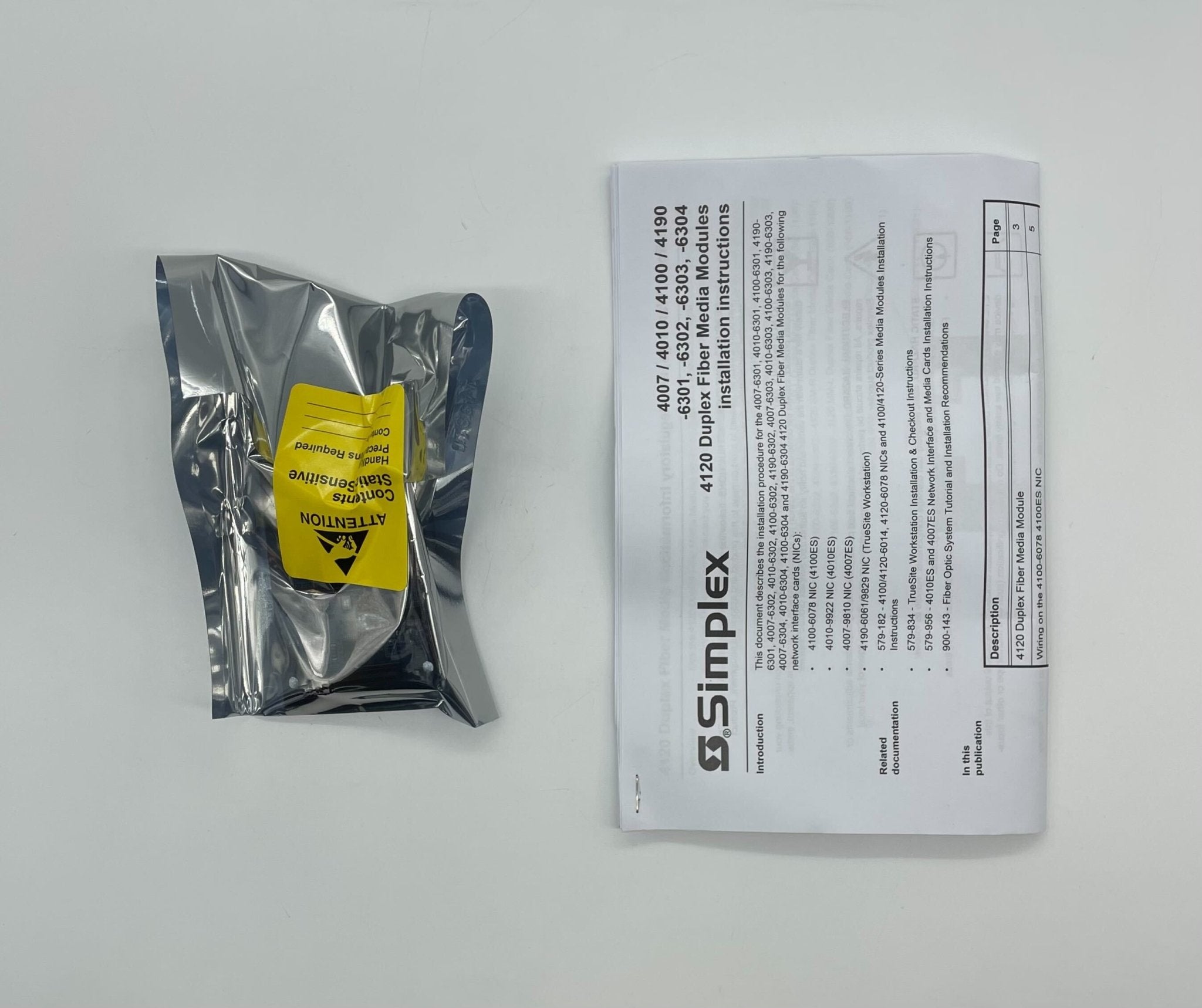 Simplex 4010-6303 fire alarm device, black with test and reset buttons, mounted on wall for fire safety detection.