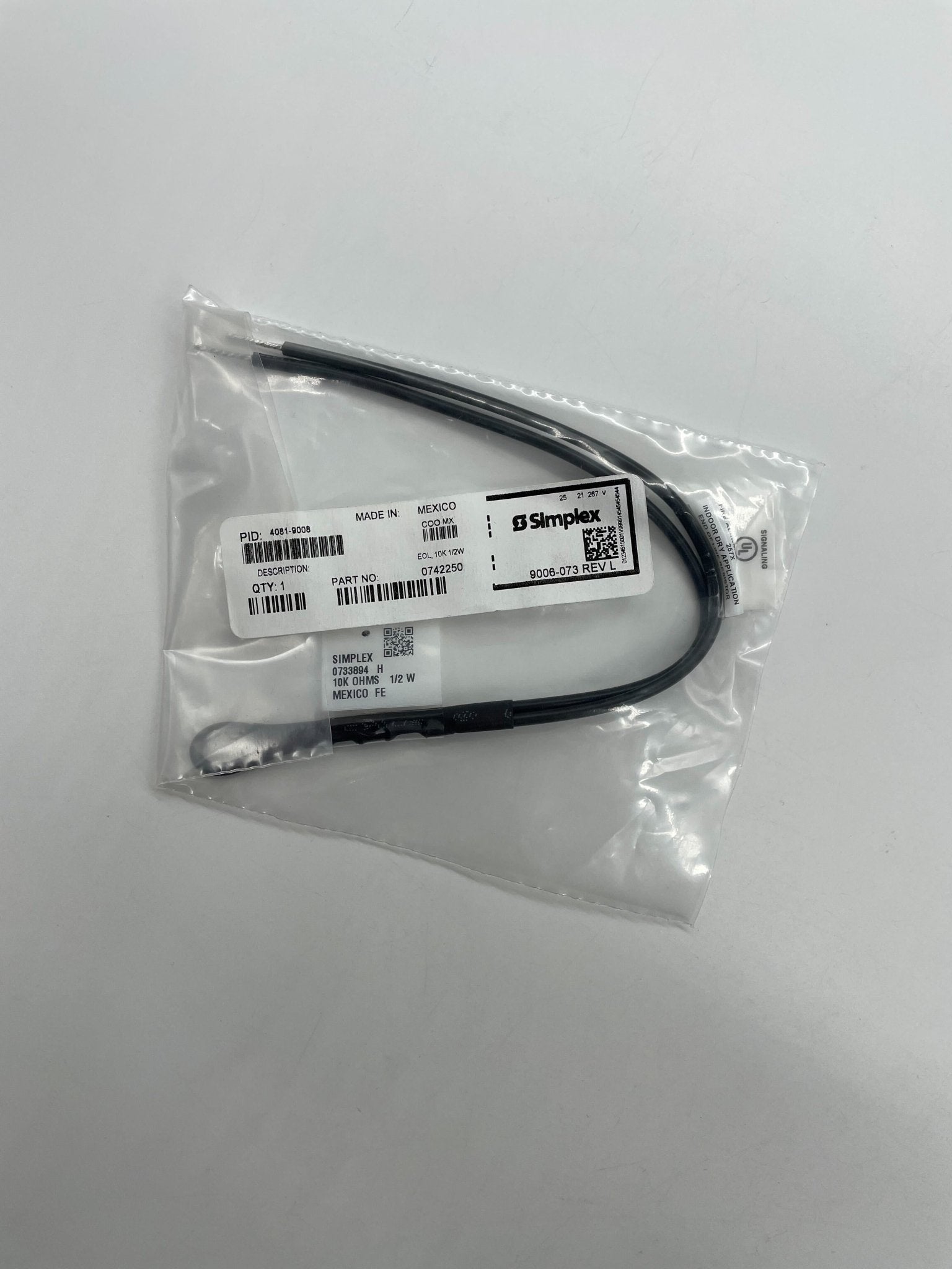 Simplex 4081-9008 fire alarm with white plastic cover, mounted on wall, essential safety device by Simplex.