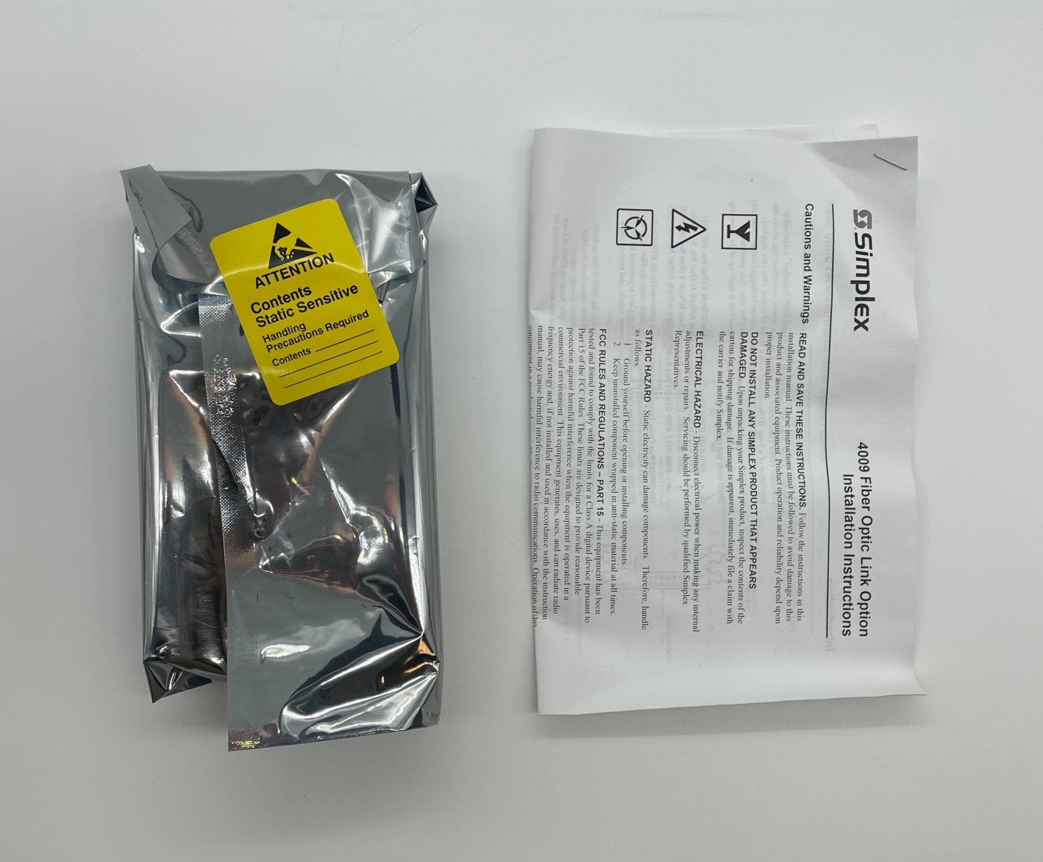 Simplex 4090-9107 fire alarm device with white plastic casing, designed for building safety and fire detection.