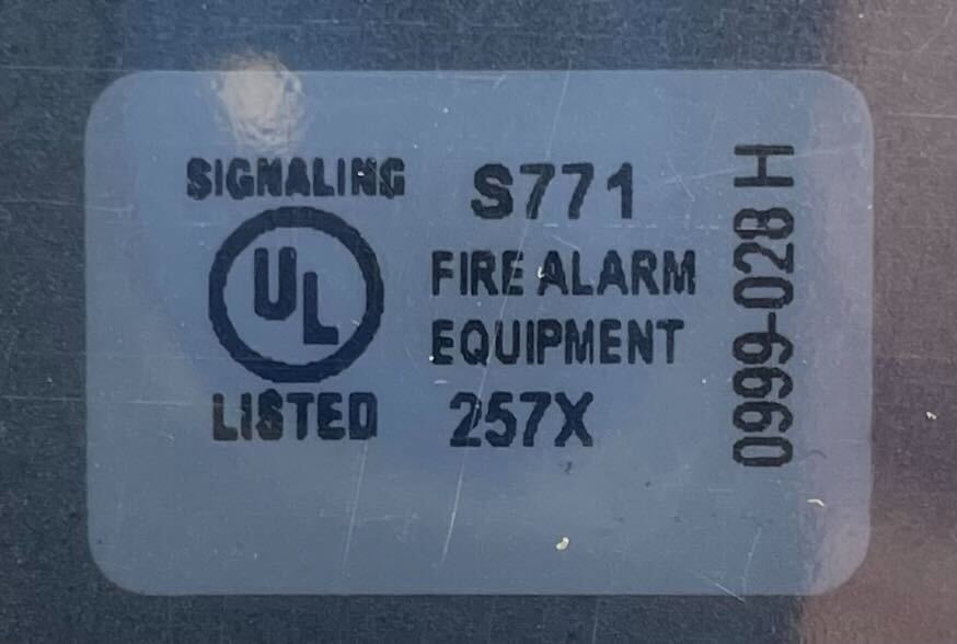 Simplex 4090-9107 fire alarm with digital display and sensor, mounted on a wall for fire safety detection.