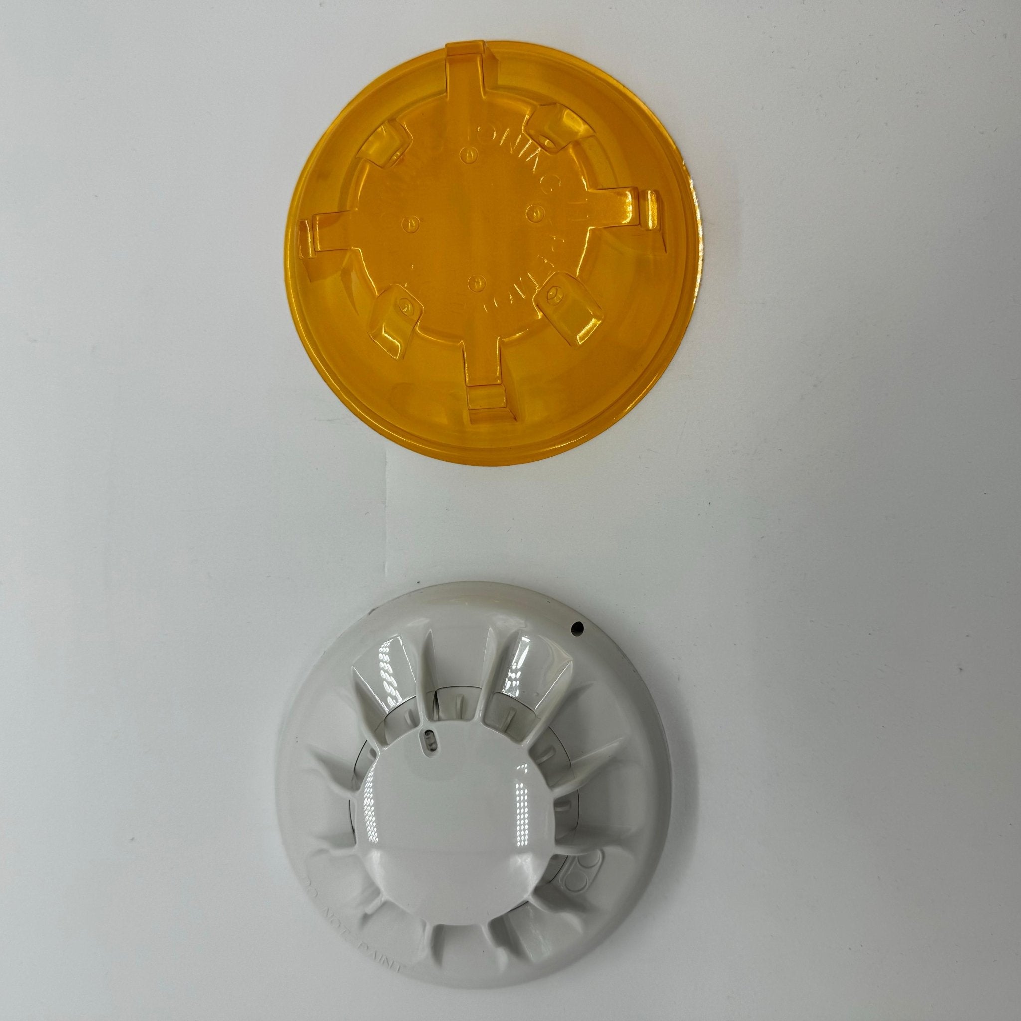 Simplex 4098-5610 heat detector, a fire alarm sensor from Simplex, shown in close-up with wiring connections visible.