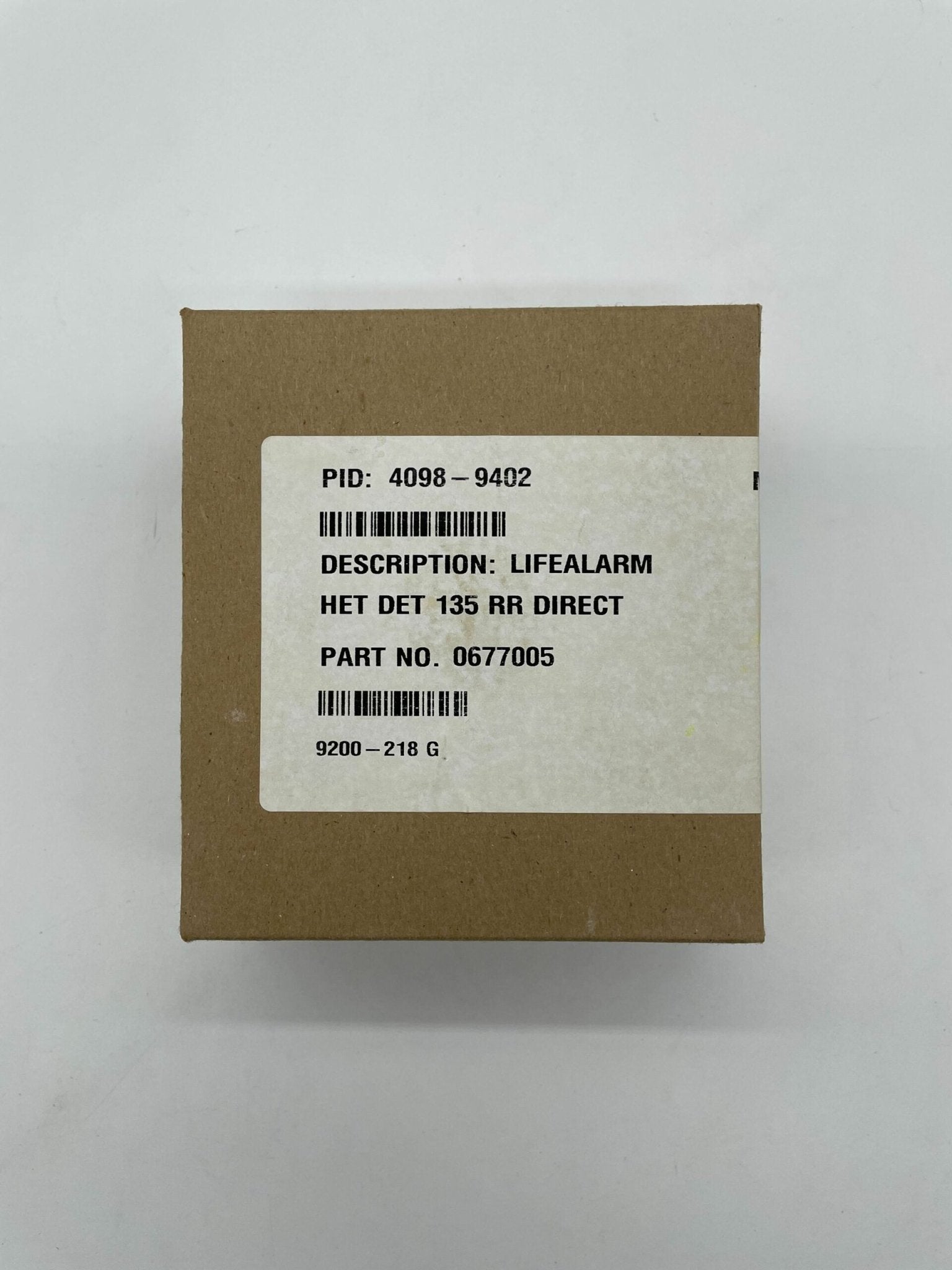 Simplex 4098-9402 heat detector with white casing and mounting bracket, used for fire safety in buildings.