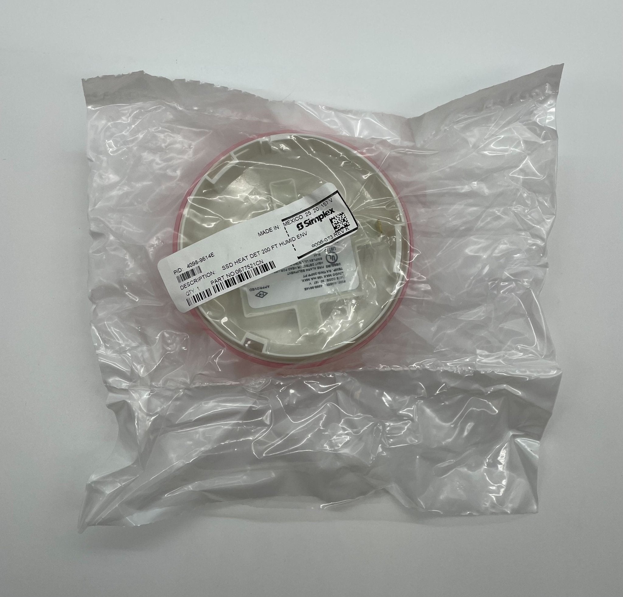 Simplex 4098-9614E heat detector, mounted on a ceiling, designed for fire safety and early heat detection in buildings.