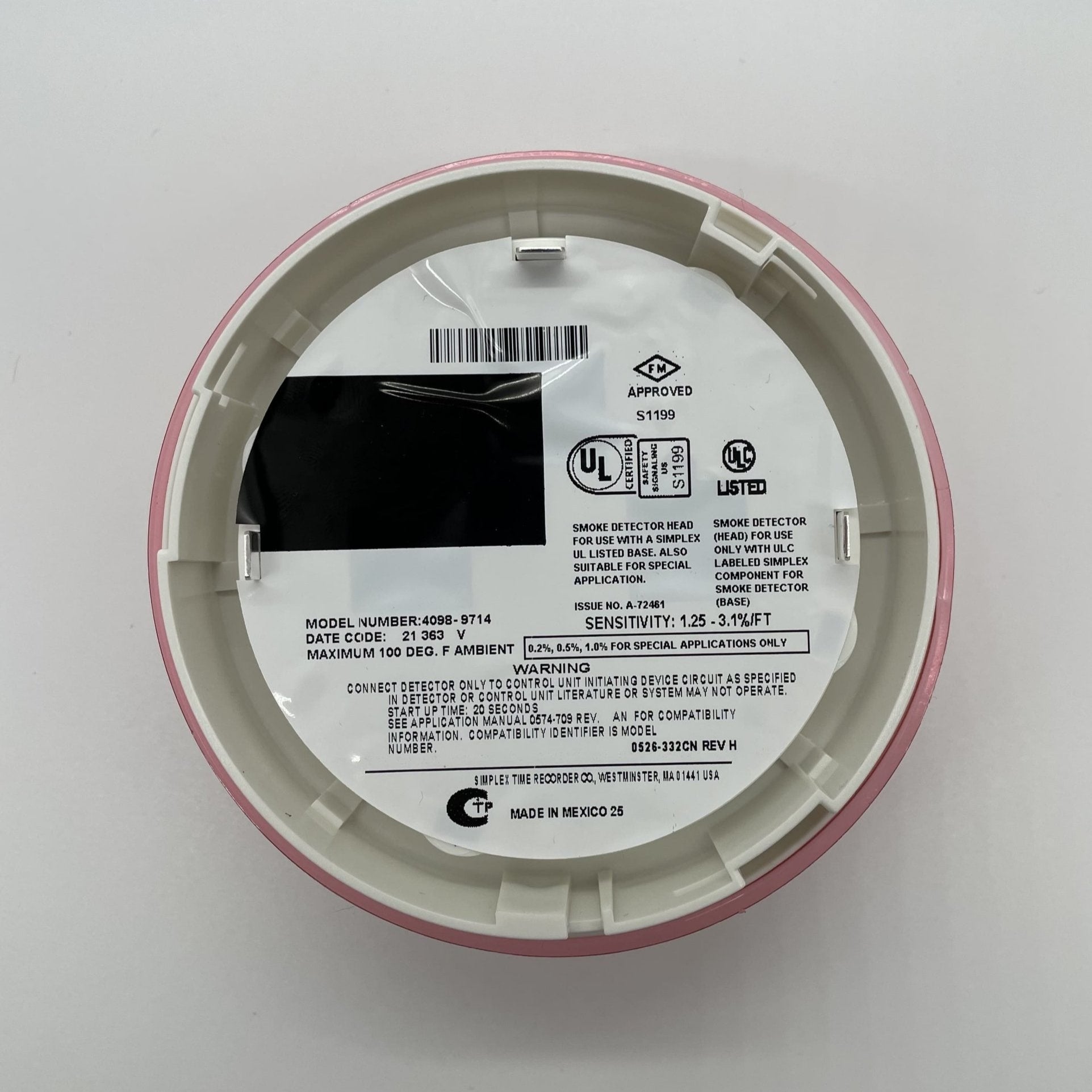 Simplex 4098-9714 photoelectric smoke detector, mounted on ceiling, designed for fire safety in residential or commercial spaces.