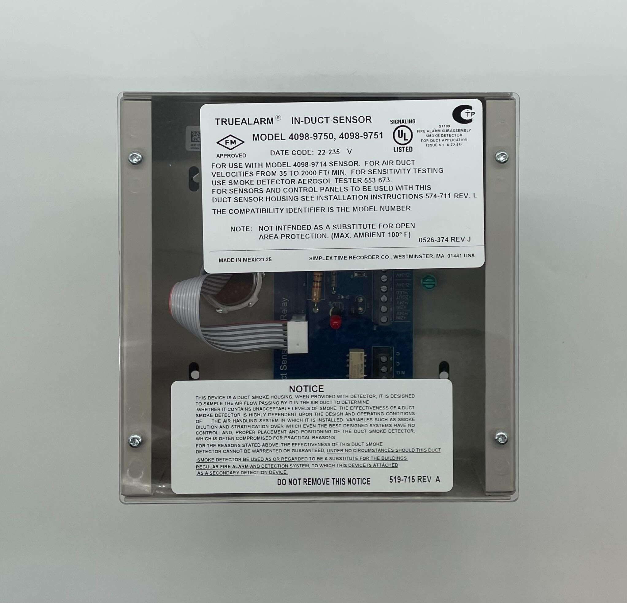 Simplex 4098-9751 duct detector mounted on a ceiling, part of Simplex fire detection system with wiring and mounting hardware visible.