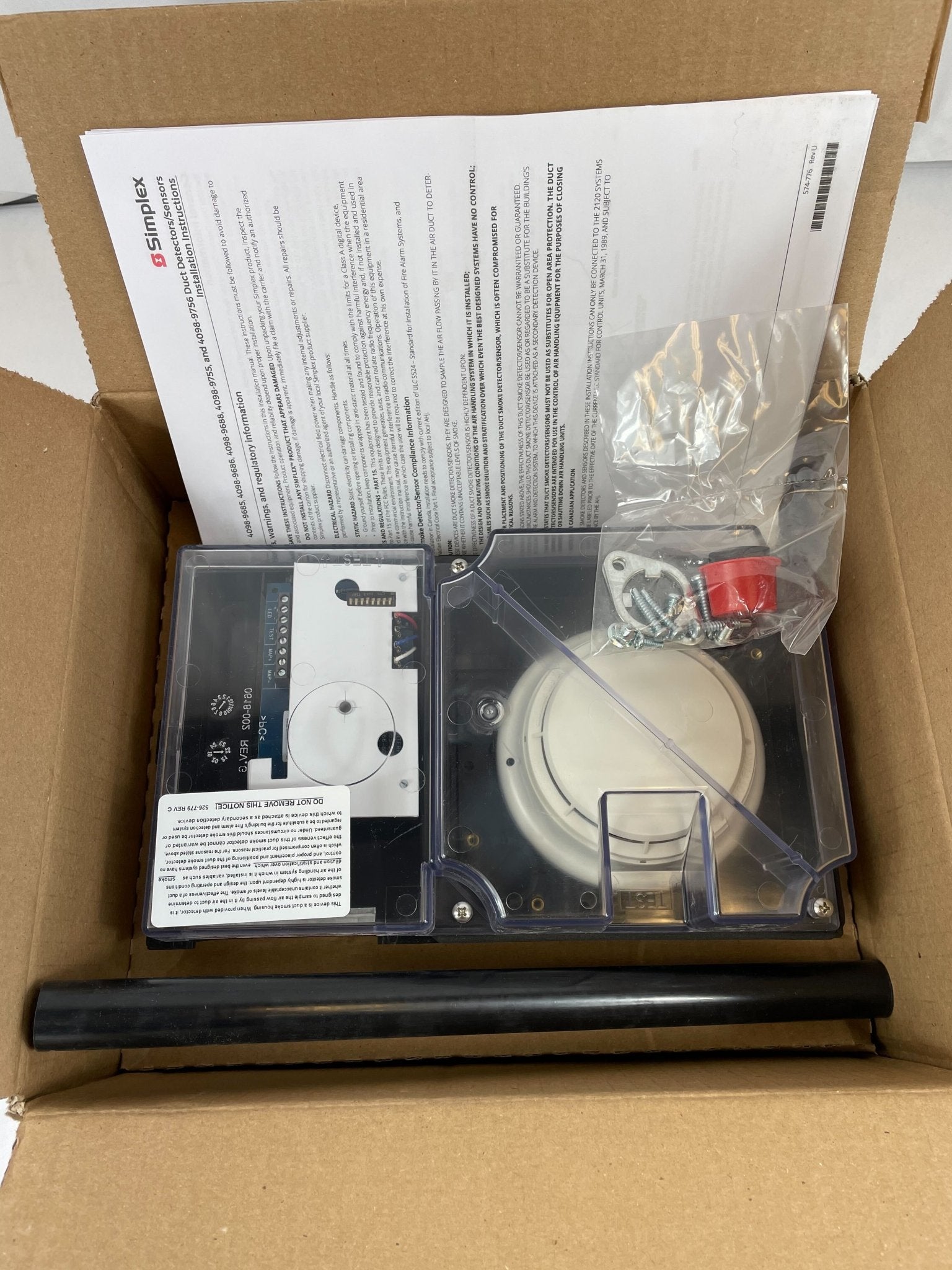 Simplex 4098-9755 duct detector installed in a commercial HVAC system, showcasing its compact design and mounting hardware.