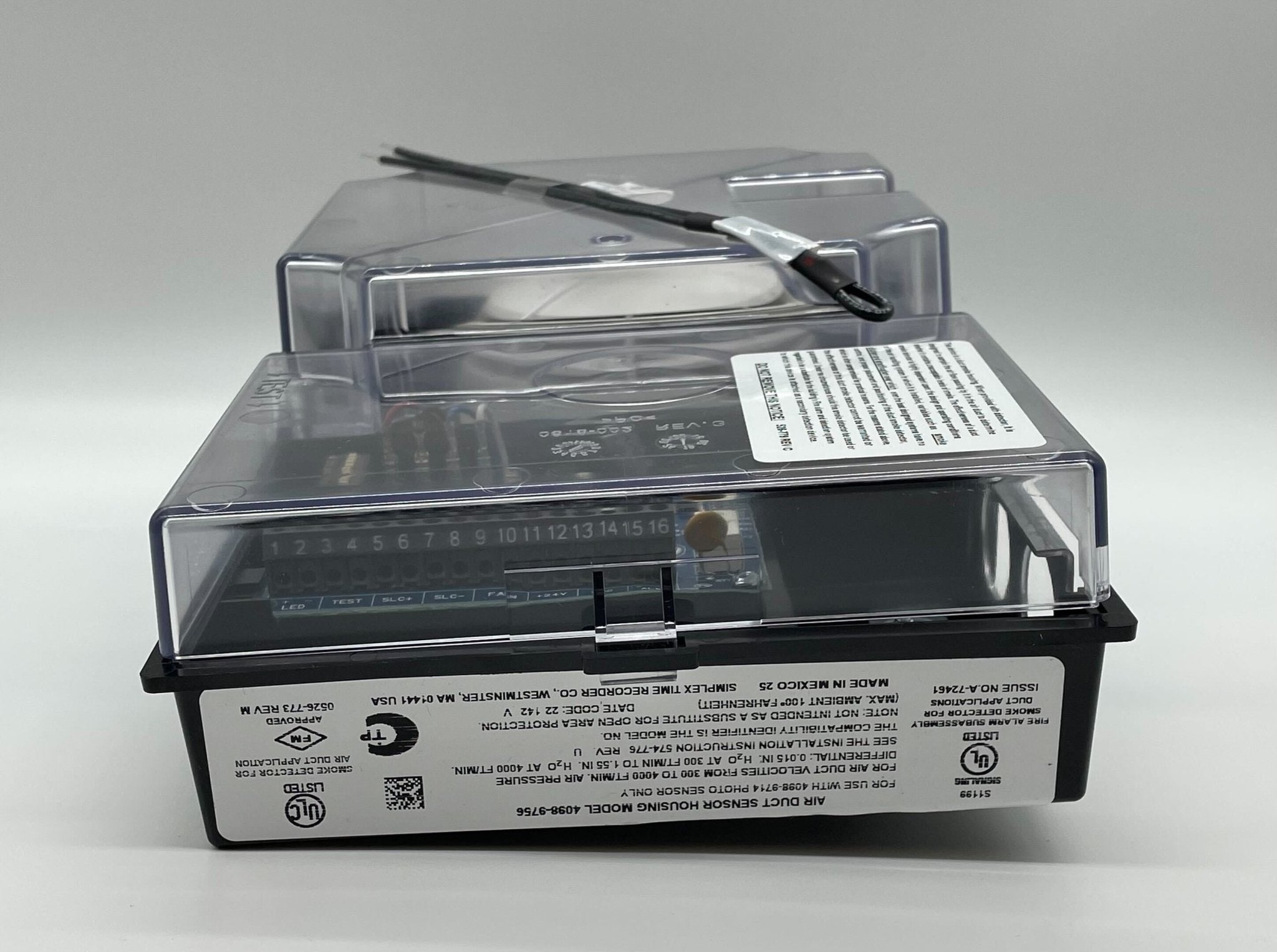 Simplex 4098-9756 duct detector installed in a commercial HVAC system, featuring a compact design and sensor components.