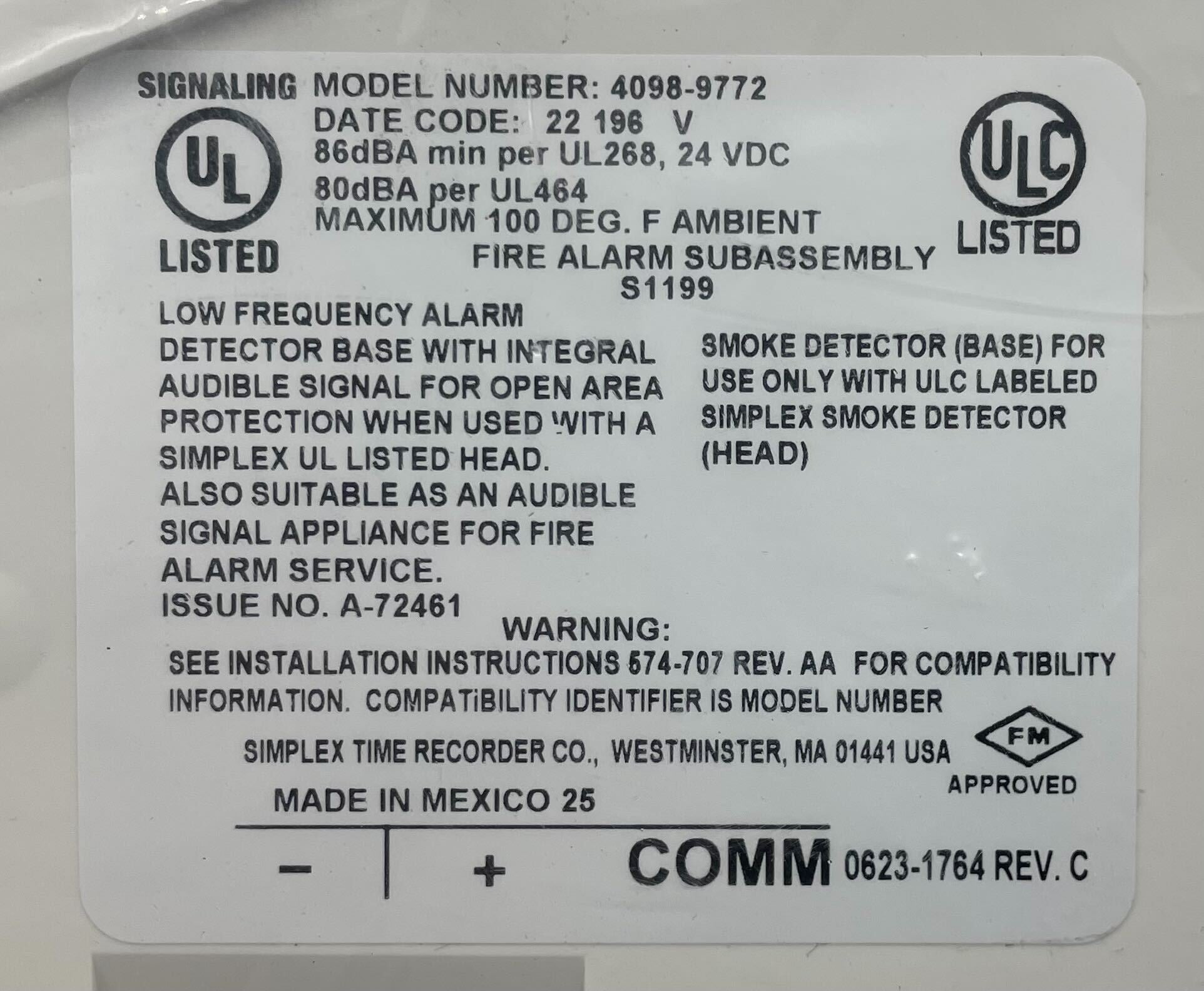 Simplex 4098-9772 base for security systems, shown in the image with a metal enclosure and connection ports.