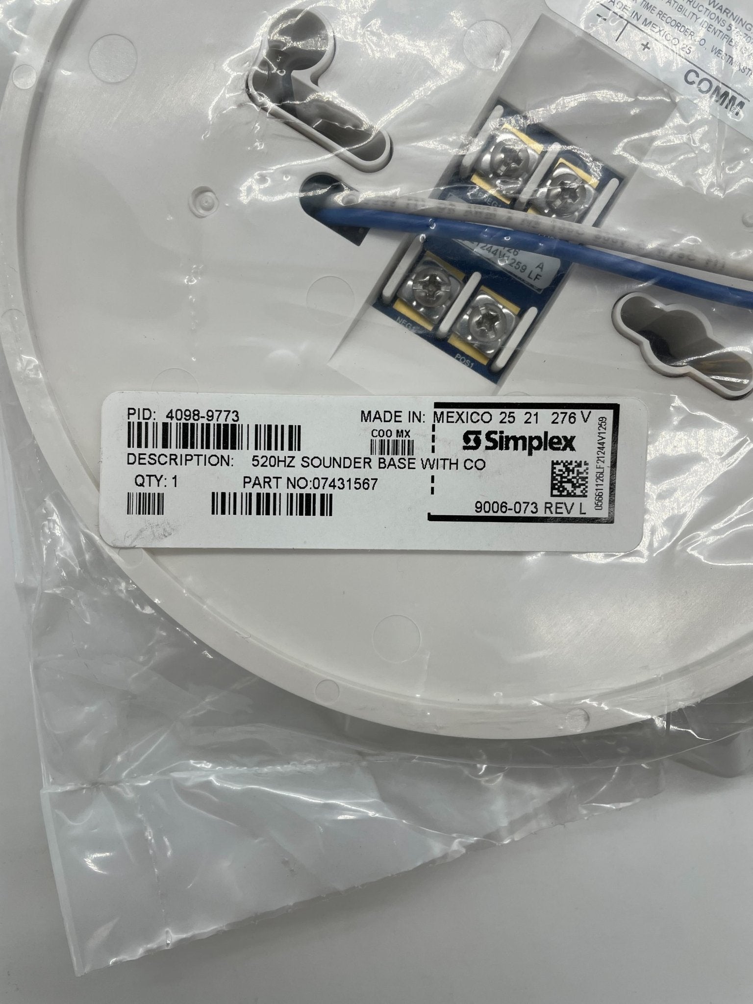 Simplex 4098-9773 base, industrial electronic component with metal and plastic parts, used in security and alarm systems.