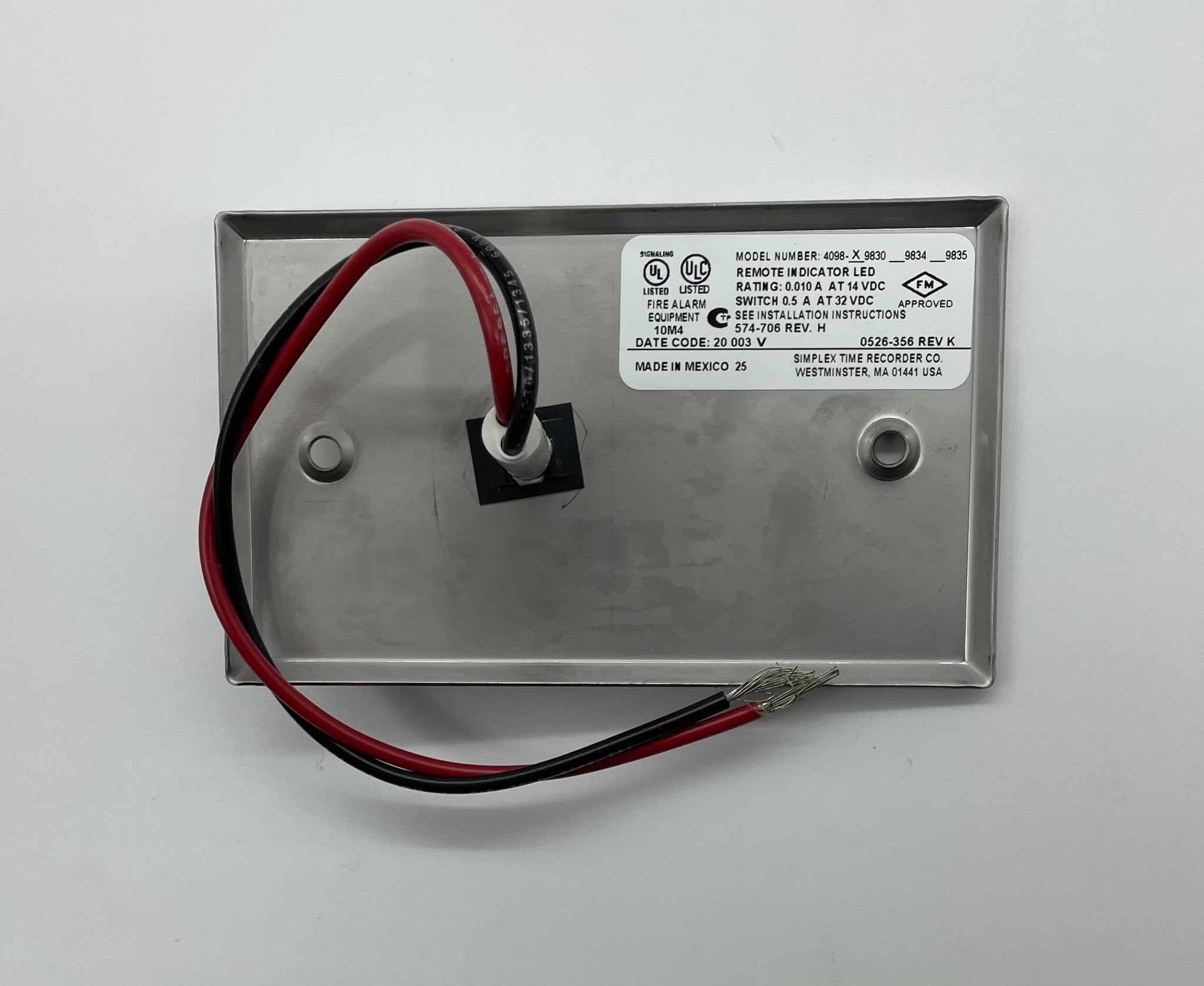 Simplex 4098-9830 fire alarm device by Simplex, mounted on a wall with visible wiring and mounting bracket.
