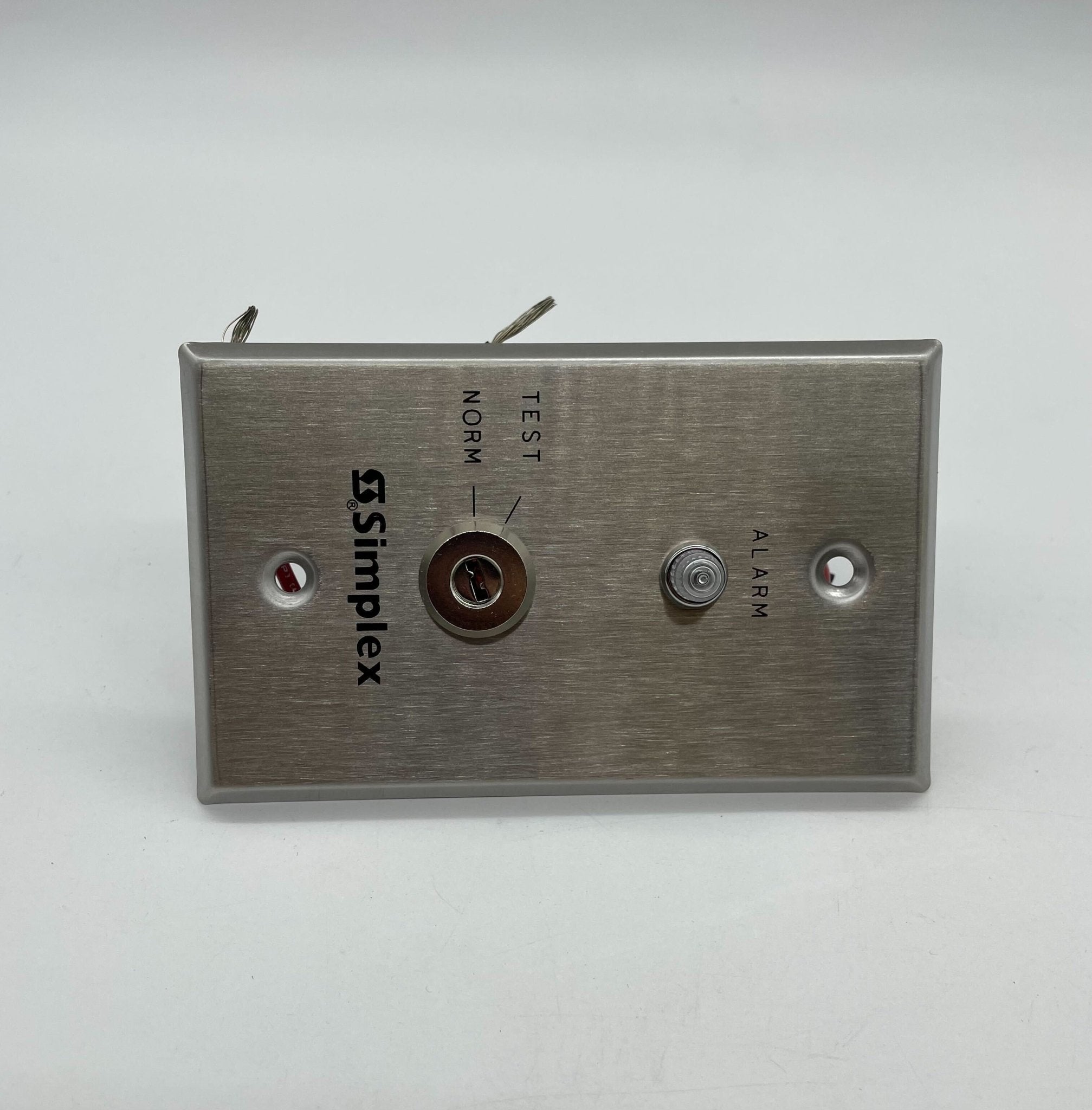 Simplex 4098-9834 fire alarm with yellow casing and test button, mounted on a wall for fire safety detection.