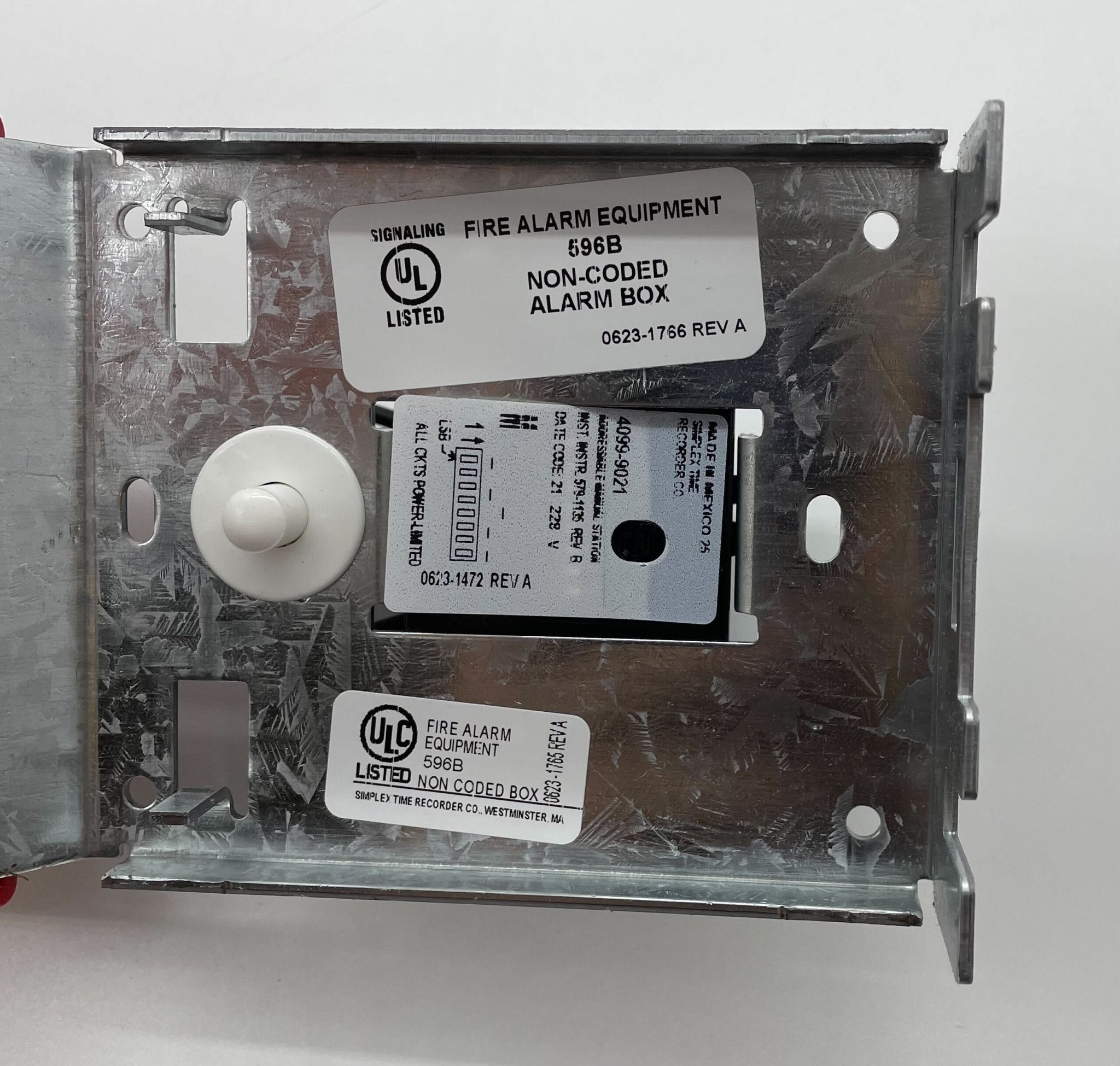 Simplex 4099-9021 pull station fire alarm device mounted on wall with label and safety instructions.