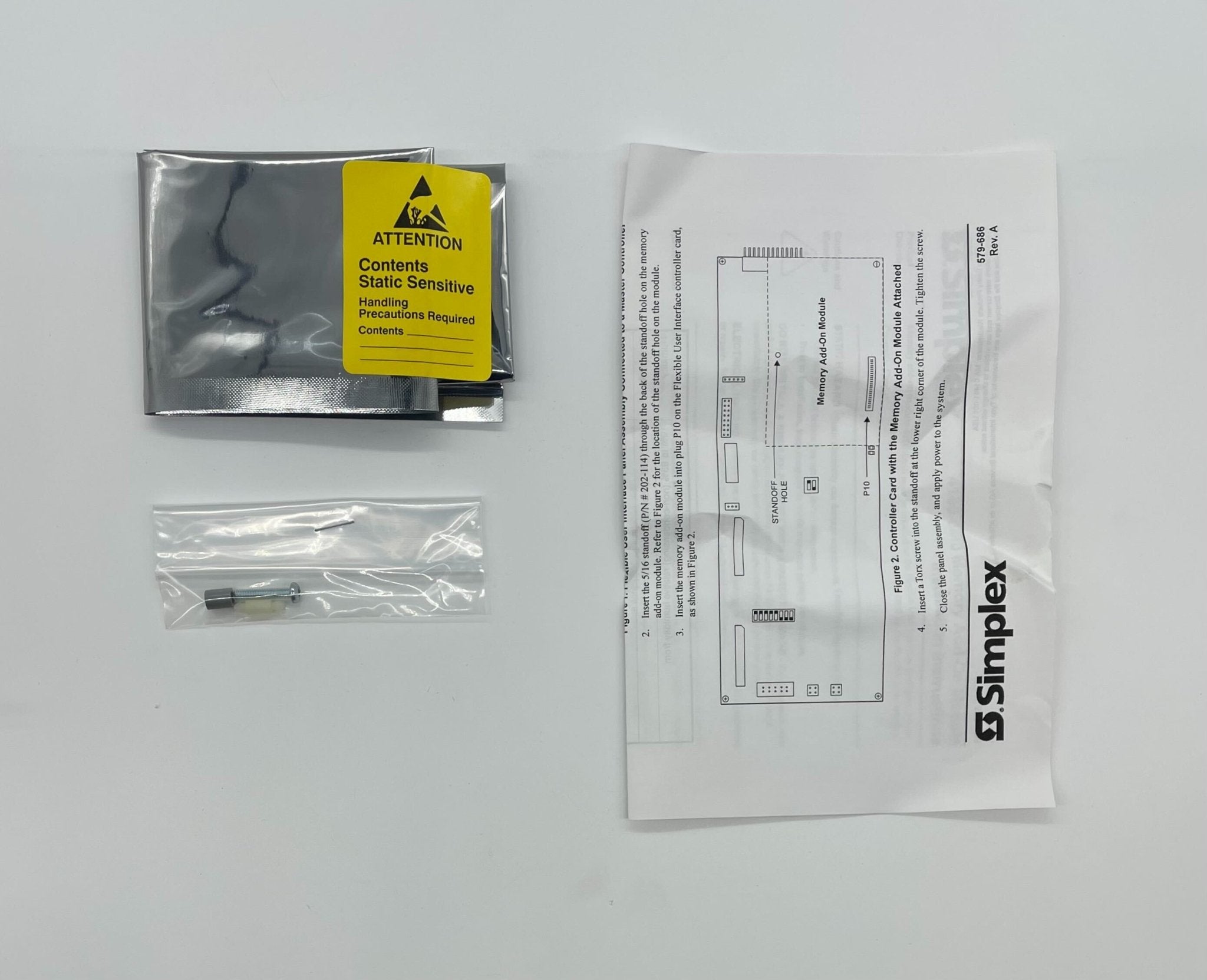 Simplex 4100-0640 fire alarm with a white control panel and indicator lights, mounted on a wall.