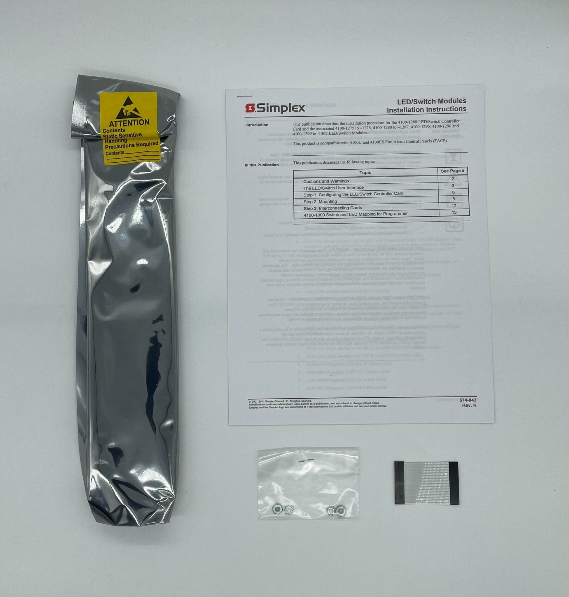 Simplex 4100-1277 fire alarm system with control panel, mounted on wall, in a commercial setting.