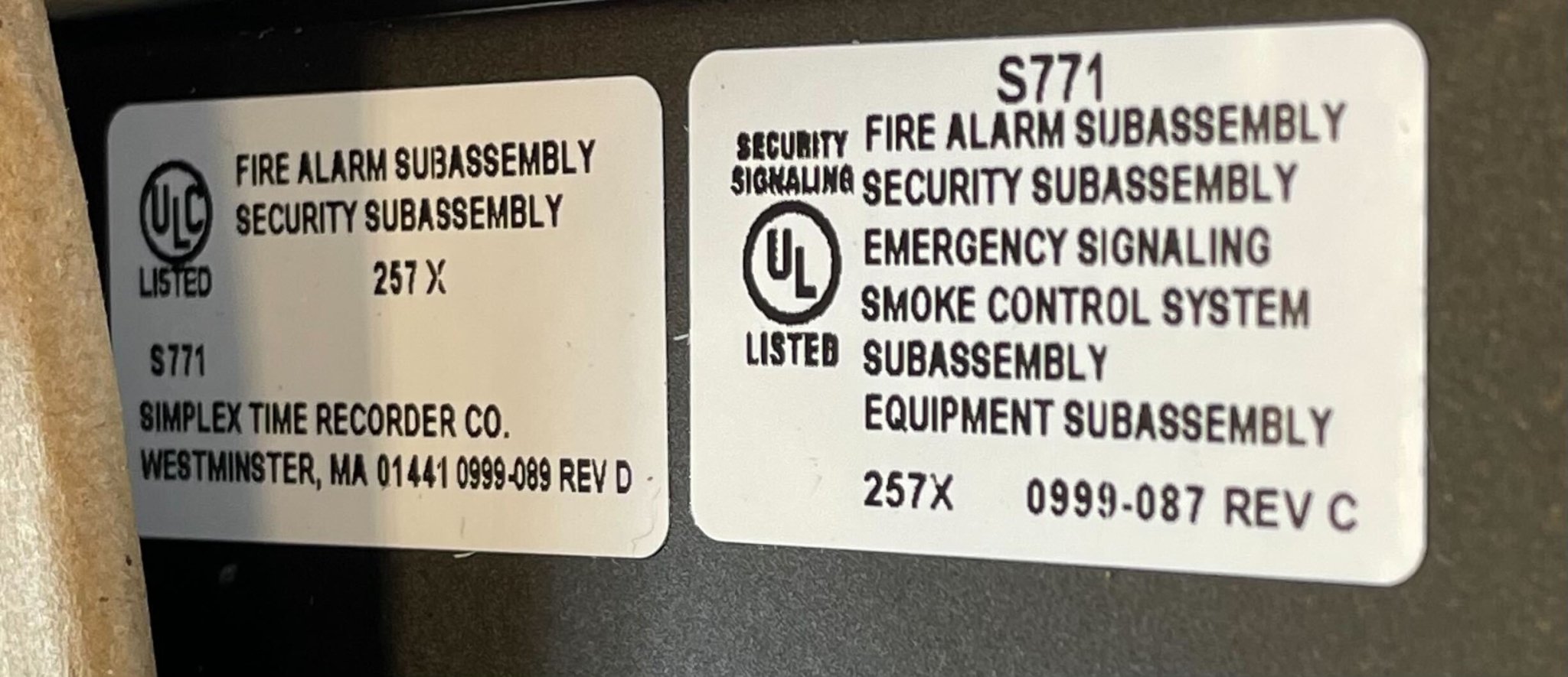 Simplex 4100-2300 fire alarm control panel with digital display and alarm indicators, installed in a commercial setting