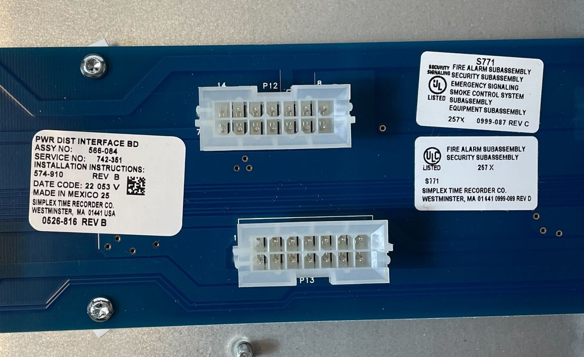 Simplex 4100-2300 fire alarm control panel with digital display and control buttons, installed in a building safety system.