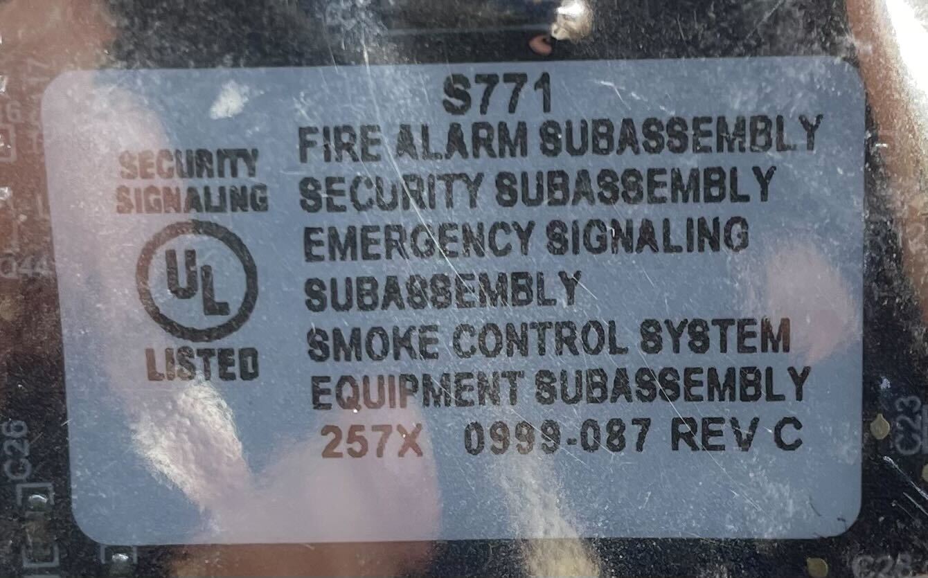 Simplex 4100-6103 fire alarm system with alarm module and control panel, installed in a building for fire safety.